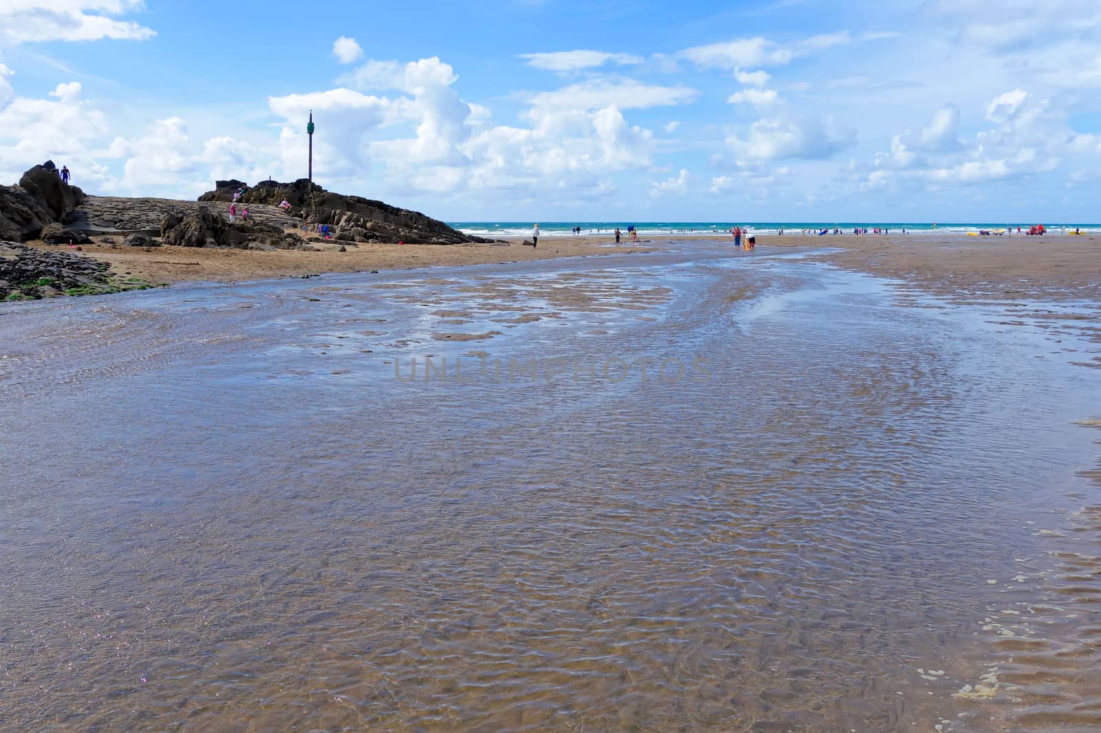 BUDE, CORNWALL/UK - AUGUST 12 : Walking along the Beach at Bude in Cornwall on August 12, 2013. Unidentified people