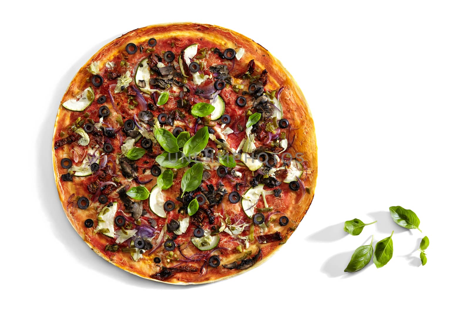 Studio shot of colourful pizza with olives, onion and basil.