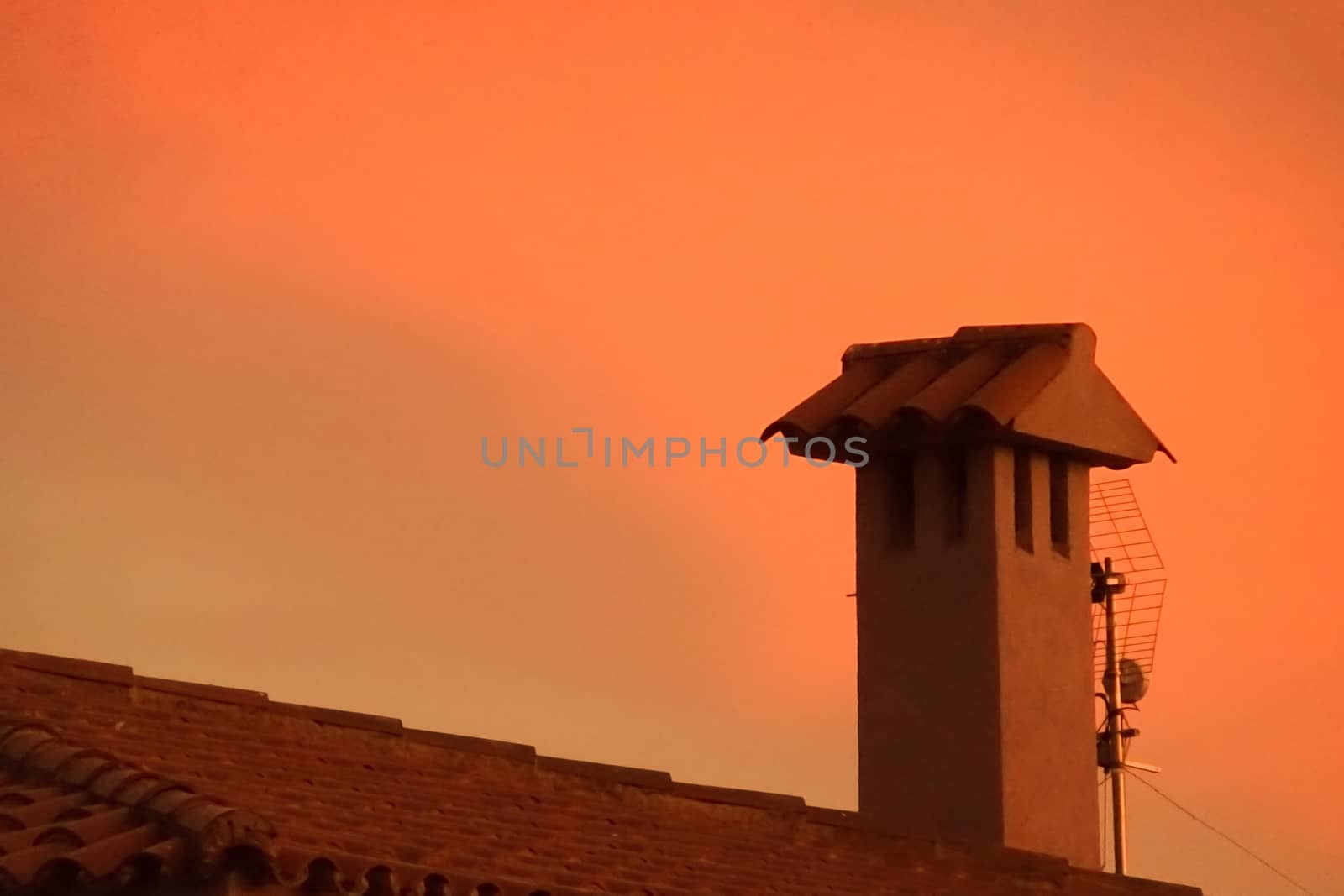 A fireplace with a red sunset in the background