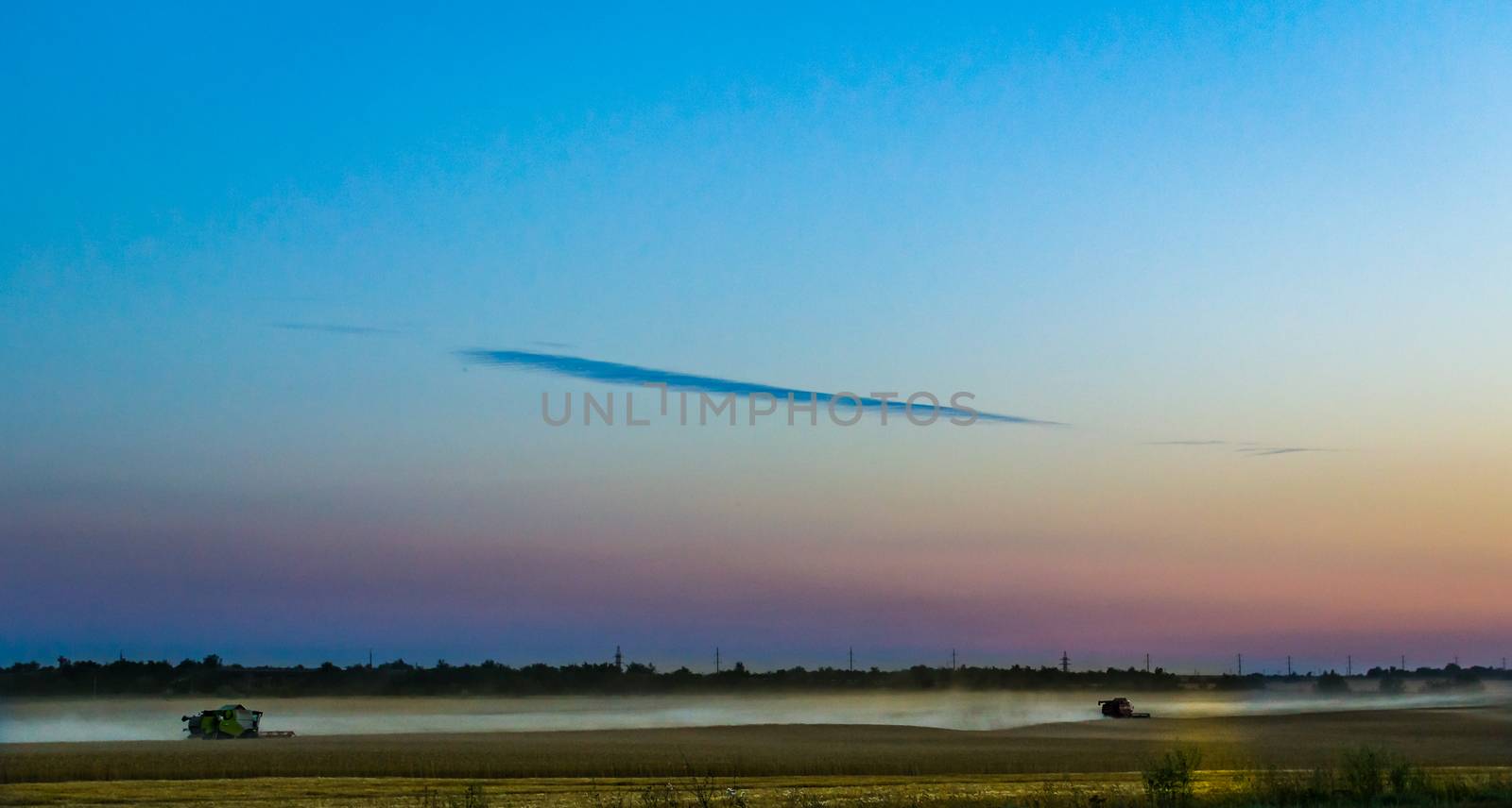 machine harvest wheat field, night moon mountains