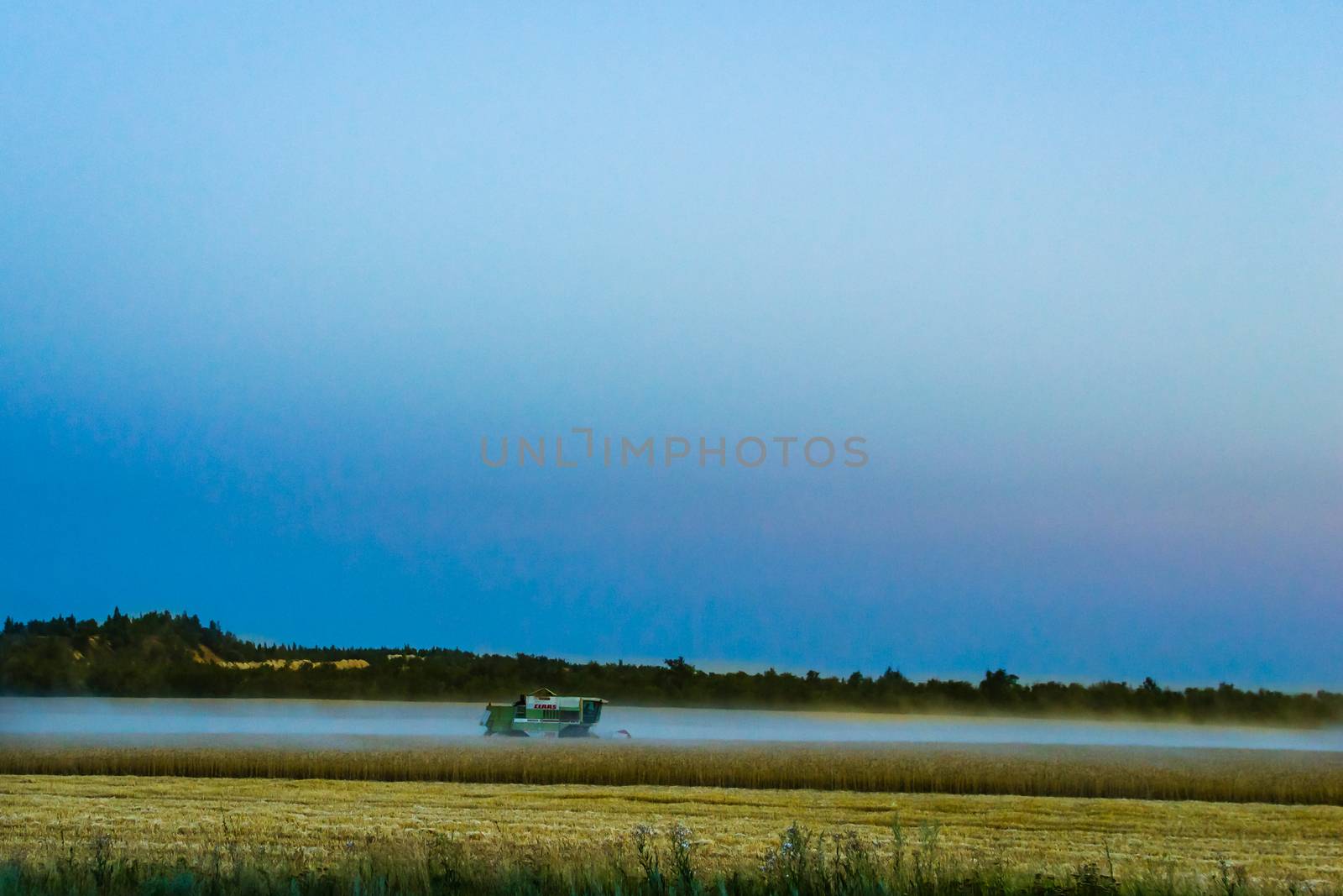 machine harvest wheat field, night moon mountains