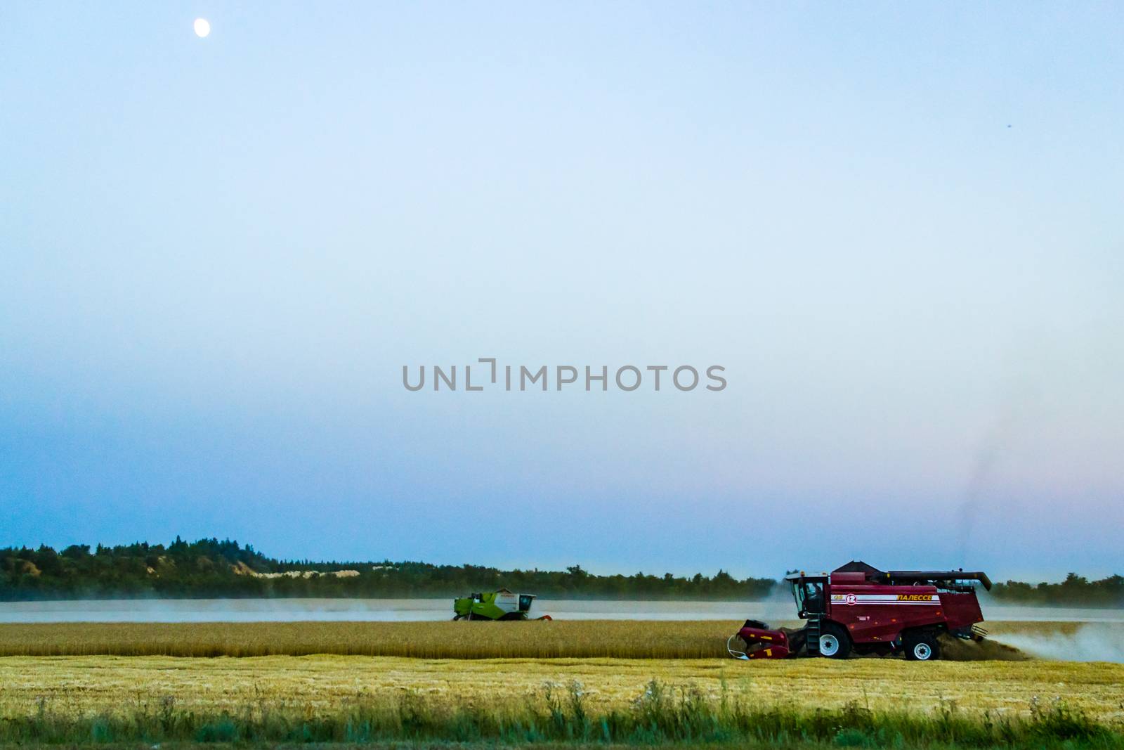 machine harvest wheat field, night moon mountains