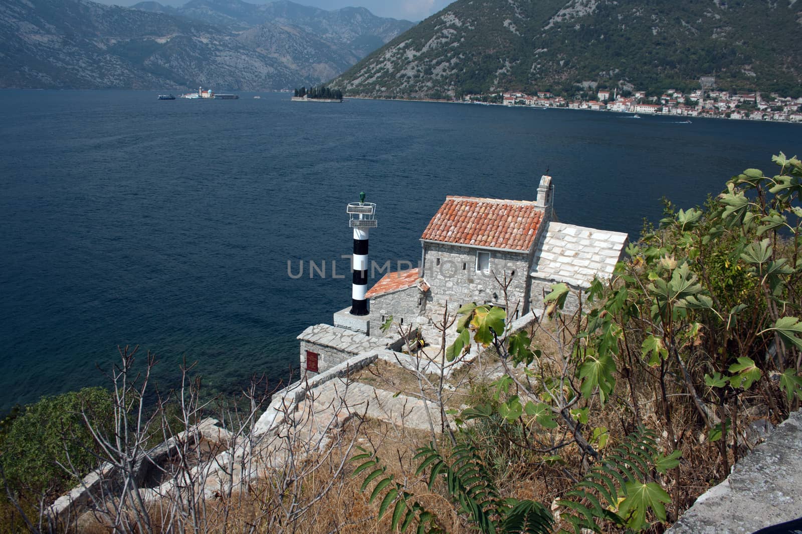 Lighthouse and medieval church,bay of Kotor, Montenegro by mslovacek
