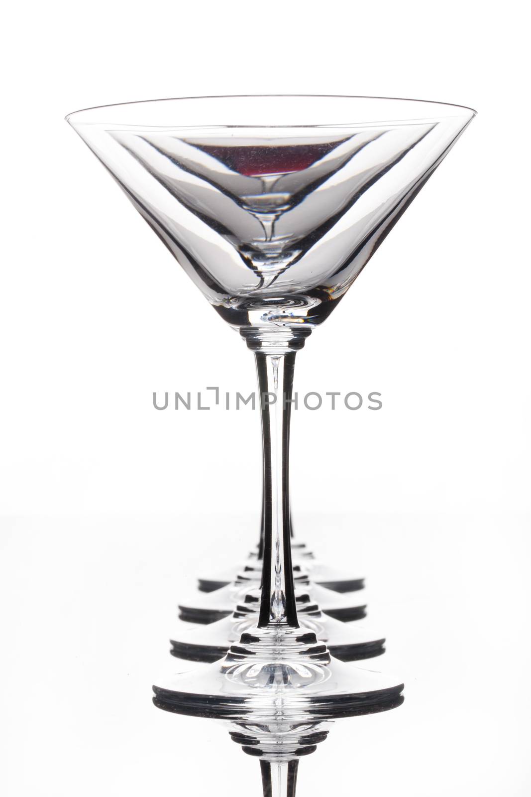 Glass with a red wine on a glass studio background