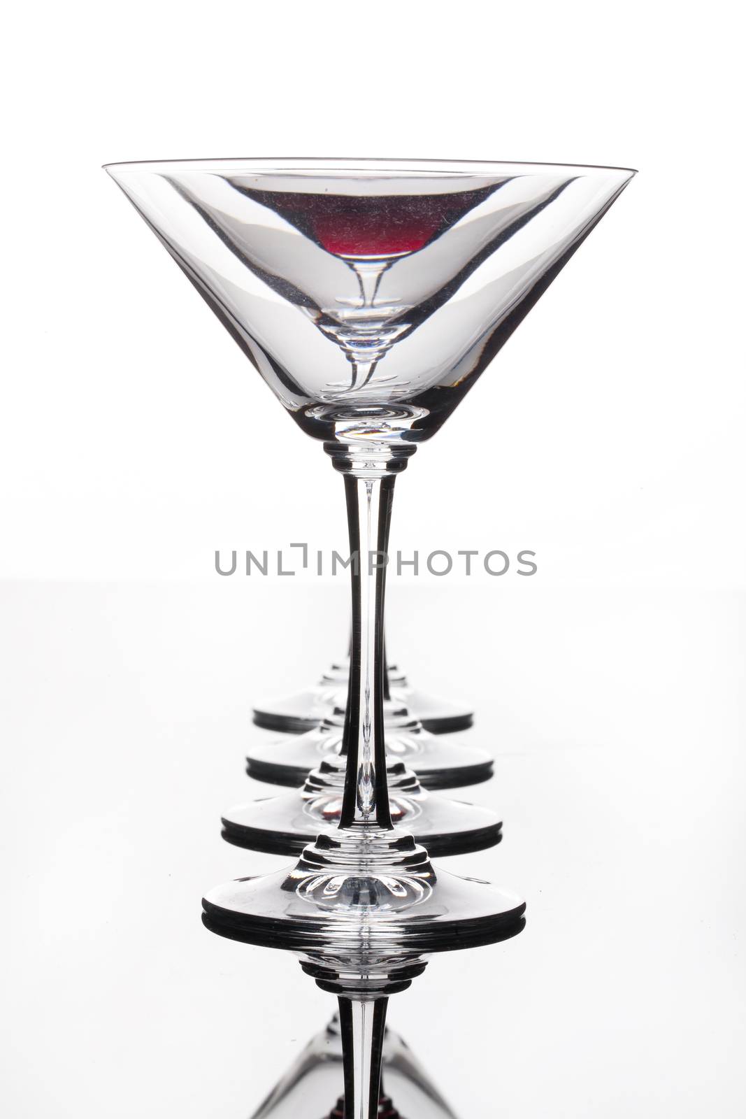 Glass with a red wine on a glass studio background