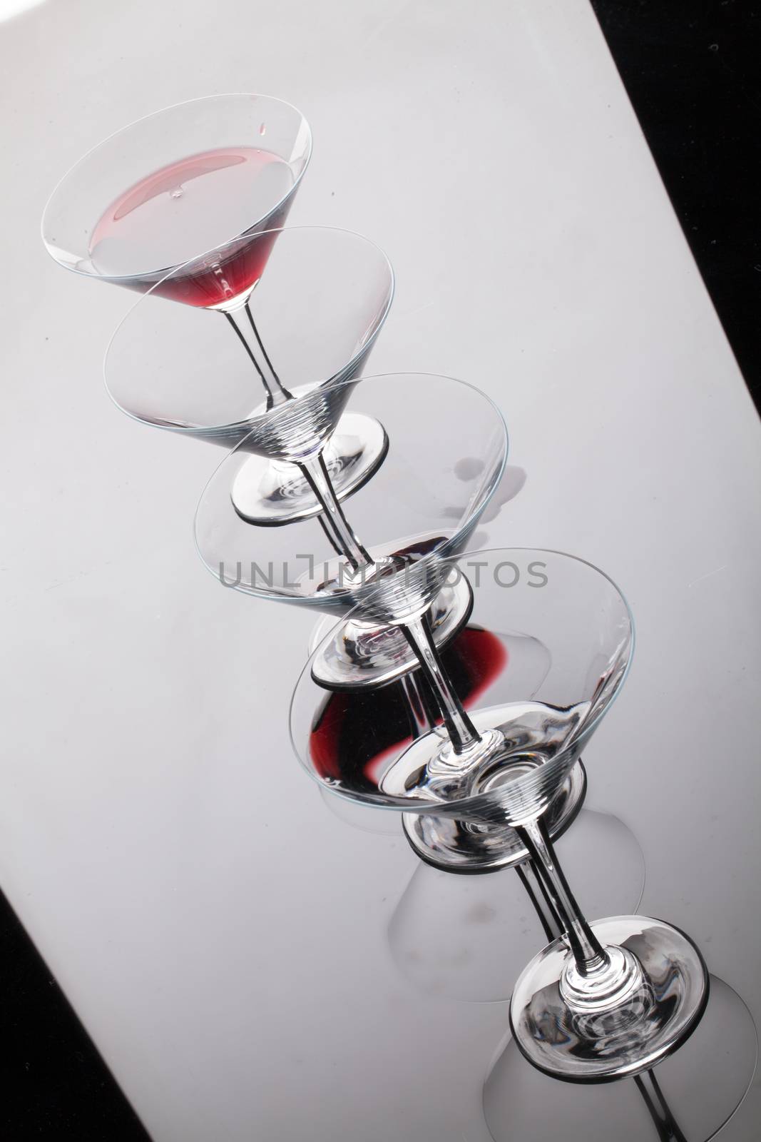 Glass with a red wine on a glass studio background