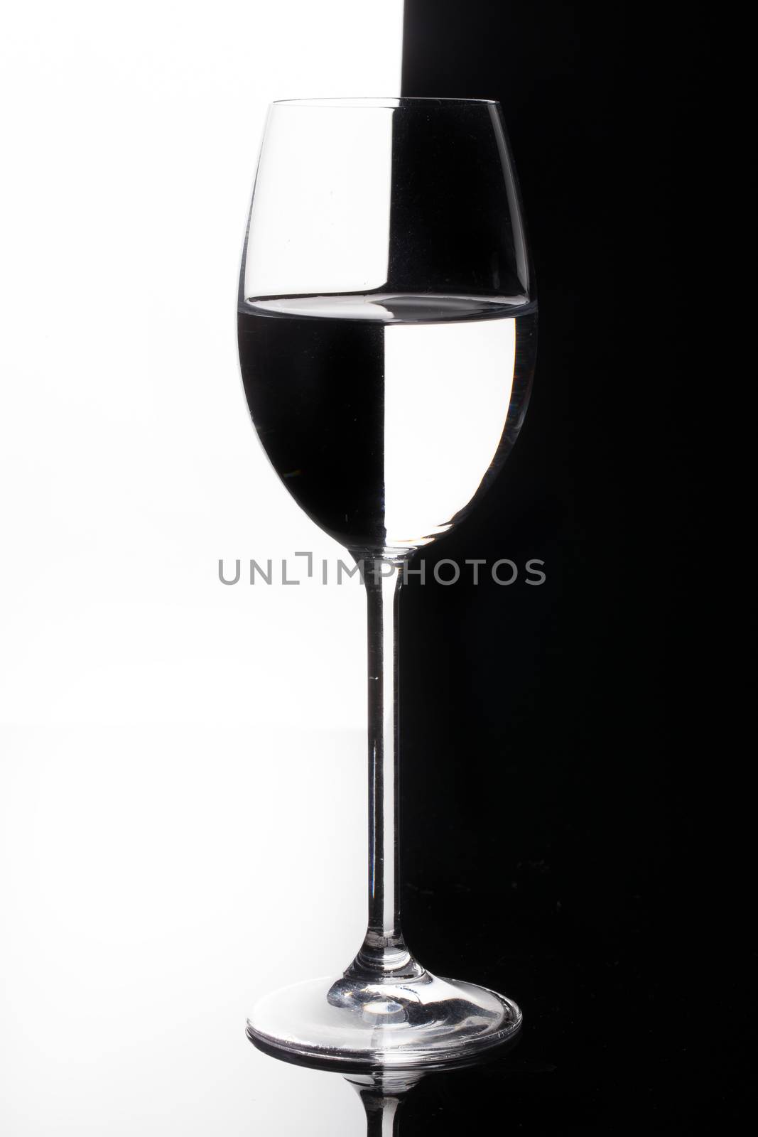 Glass with a red wine on a glass studio background