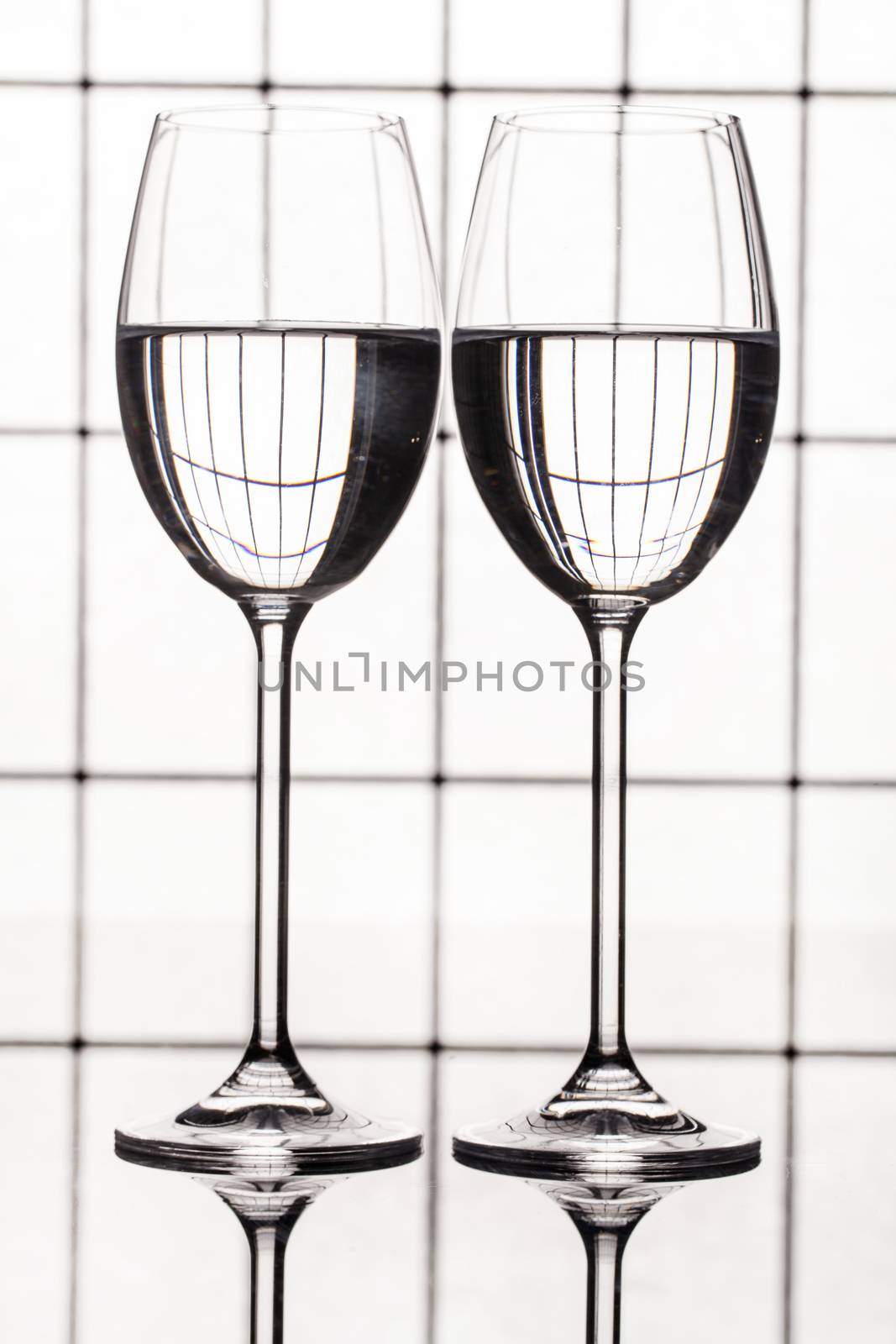 Glass with a red wine on a glass studio background