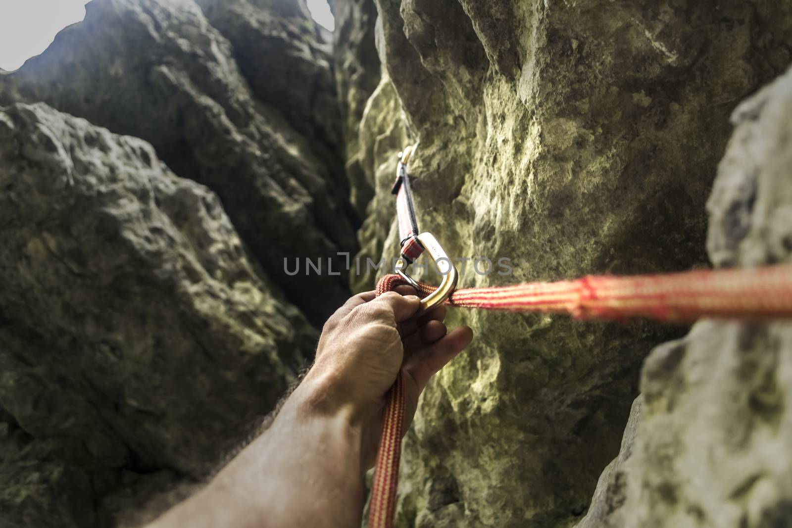 Climber's hand and rope by oleksandrmazur