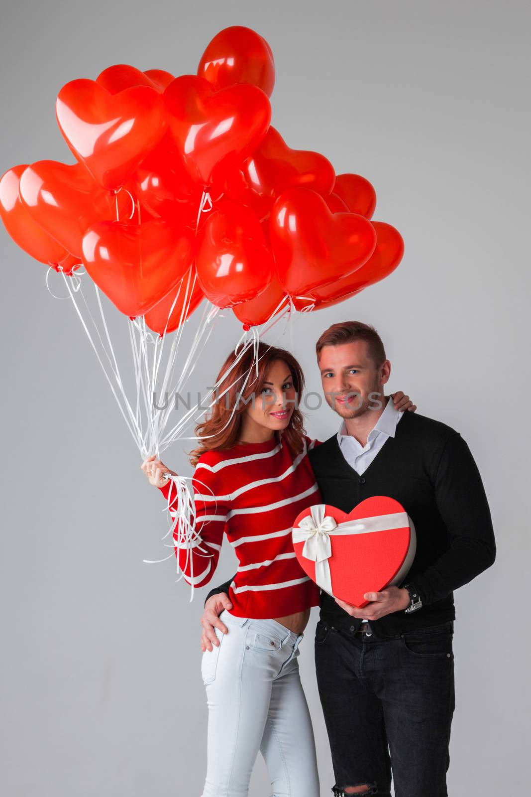 Couple with heart shaped balloons and gifts, Valentines day