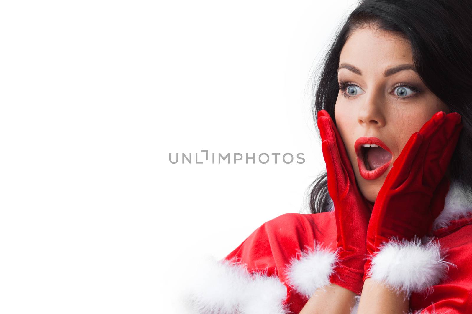 Pretty surprised Pin-up style Santa girl in red hat on white background
