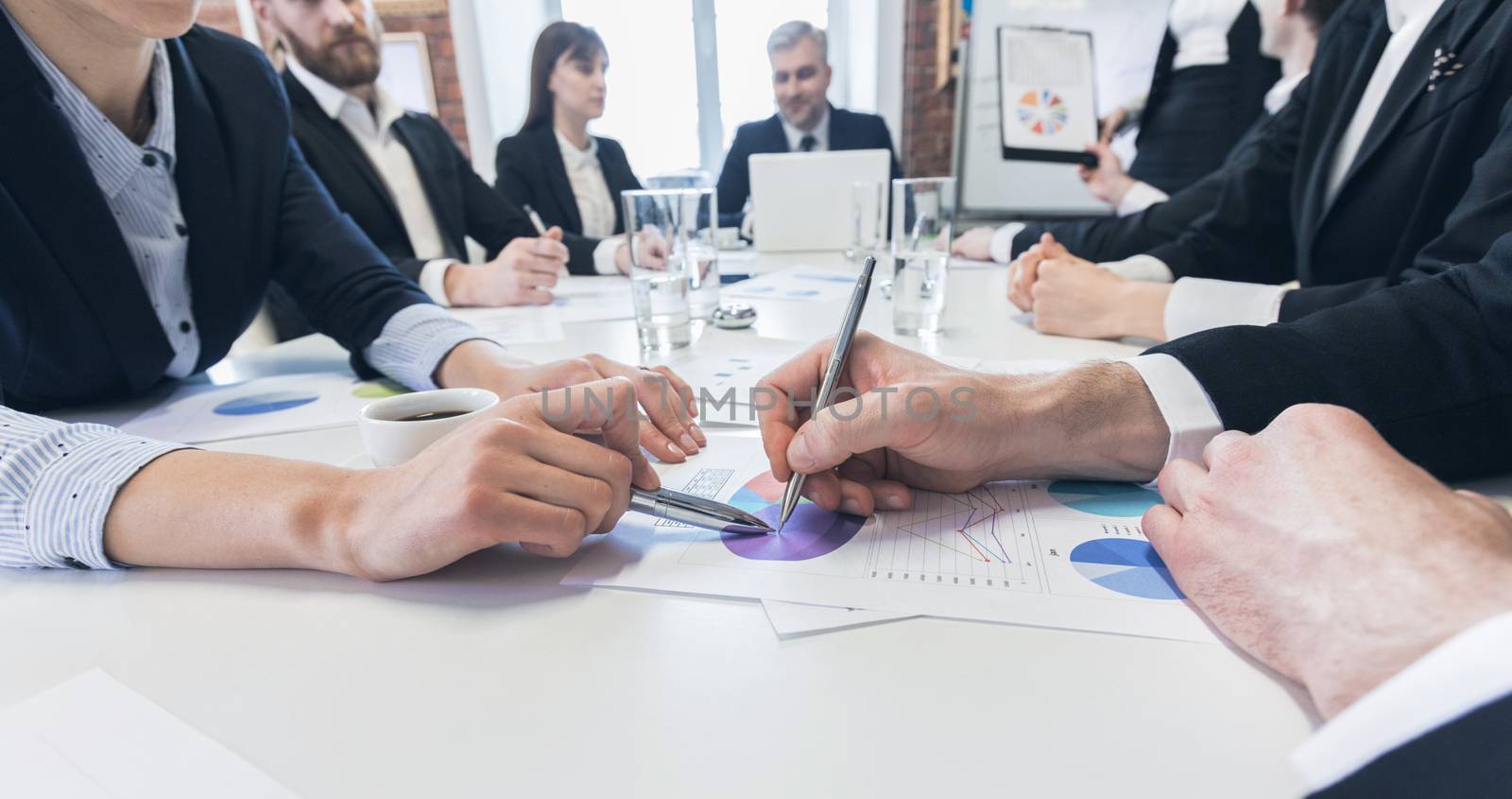 Business people team discussing financial stockmarket charts in office