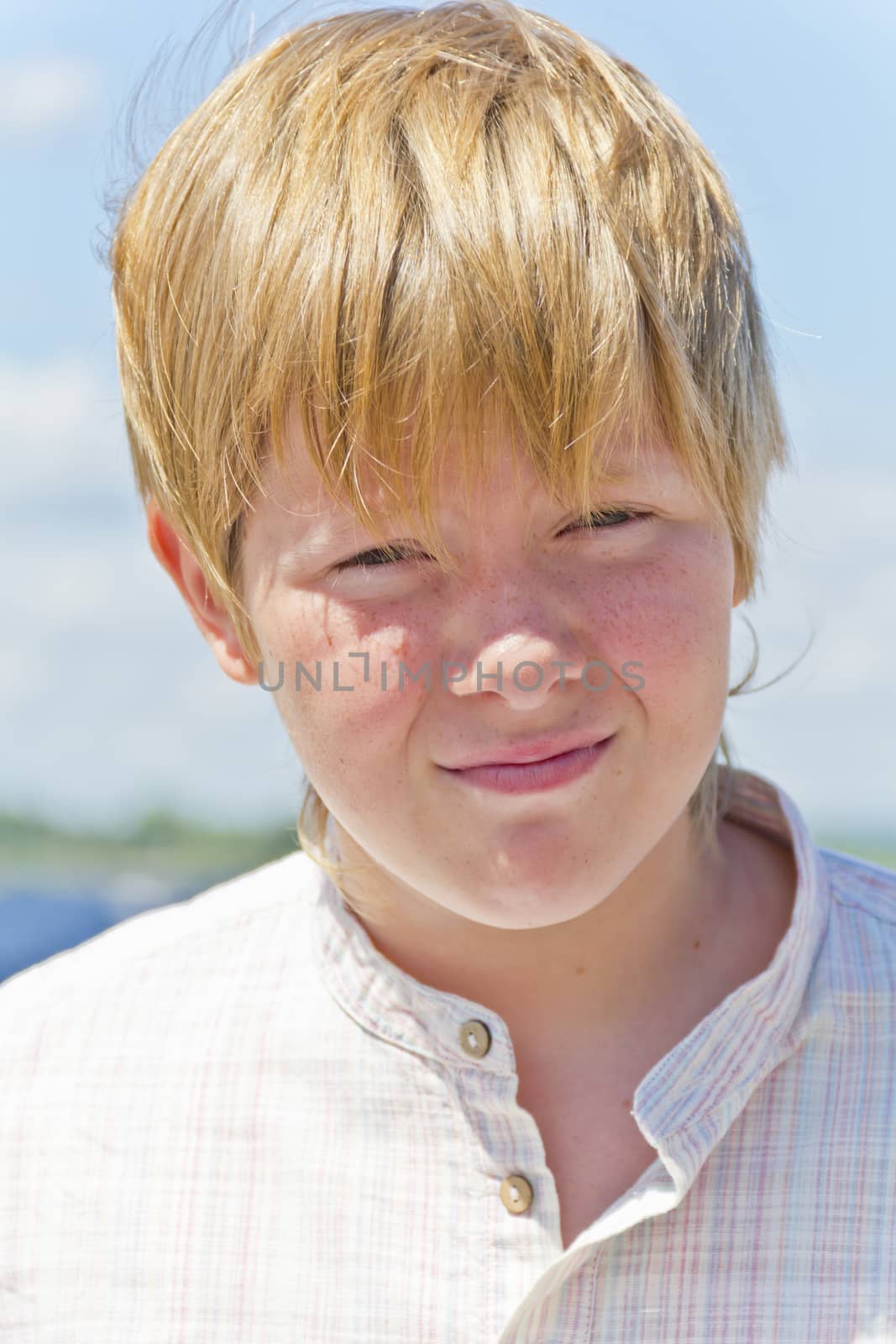 Portrait of serious boy in summer sunny day