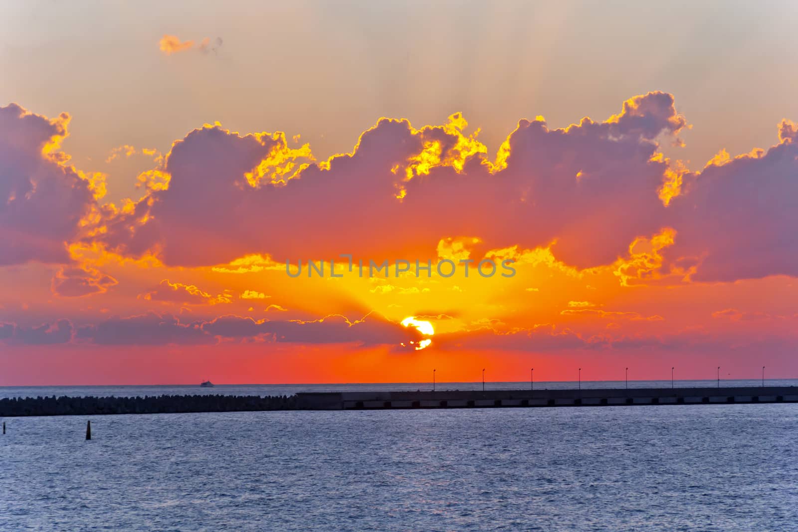 Picturesque skyscape of evening sea with red sunset