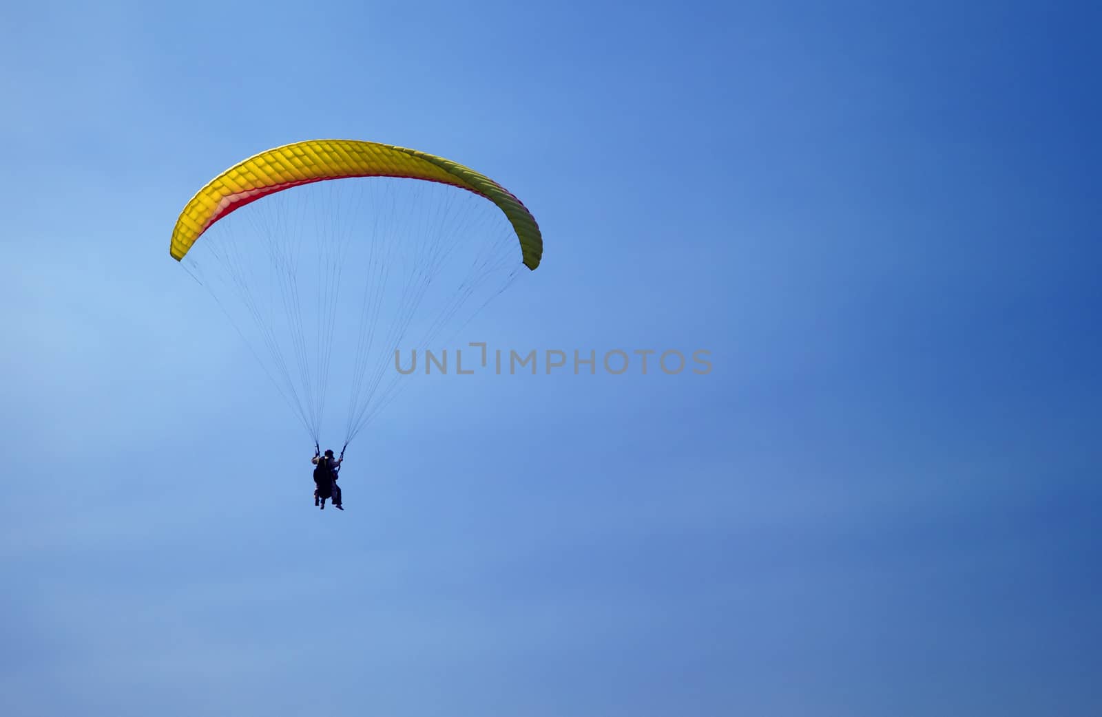Parasailing in a blue sky in Chimgan mountains, Uzbekistan