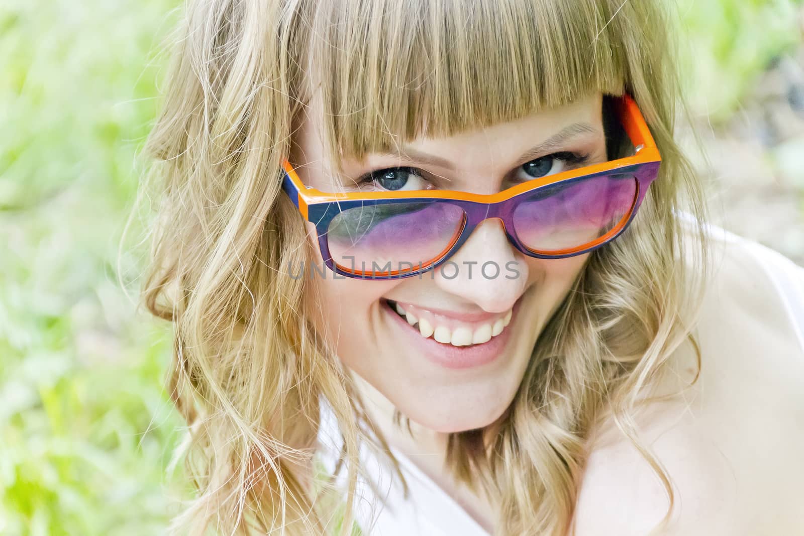 Portrait of smiling girl with orange sunglasses