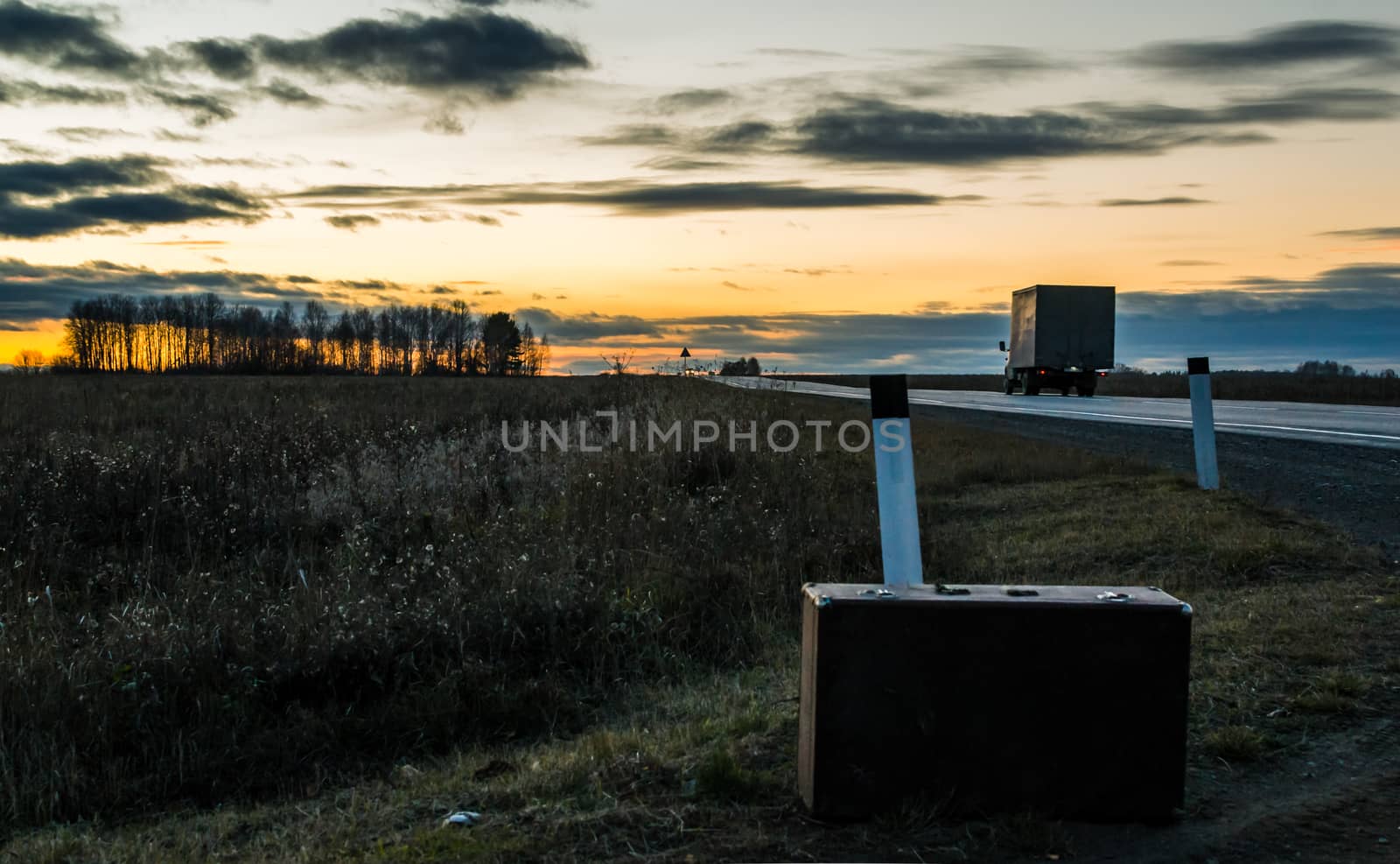 Autumn road home suitcase travel the road in the evening