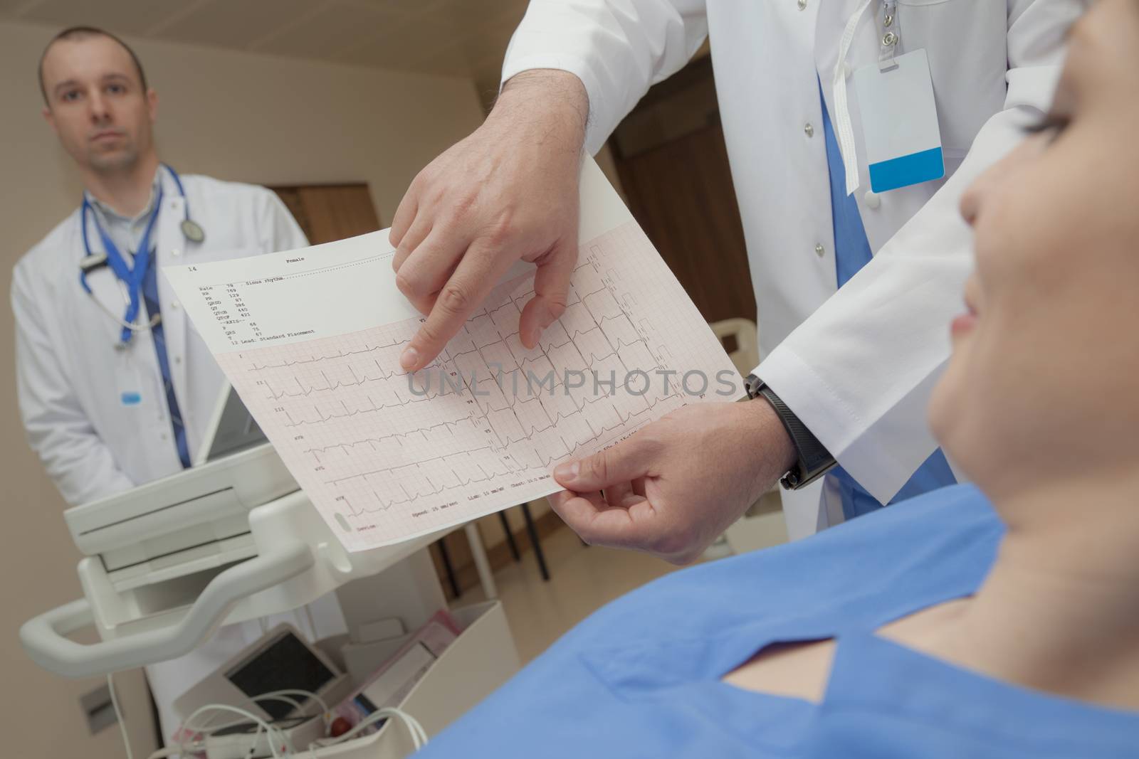 A cardiogram with a normal heart beat rate is shown to a pleased young female patient.