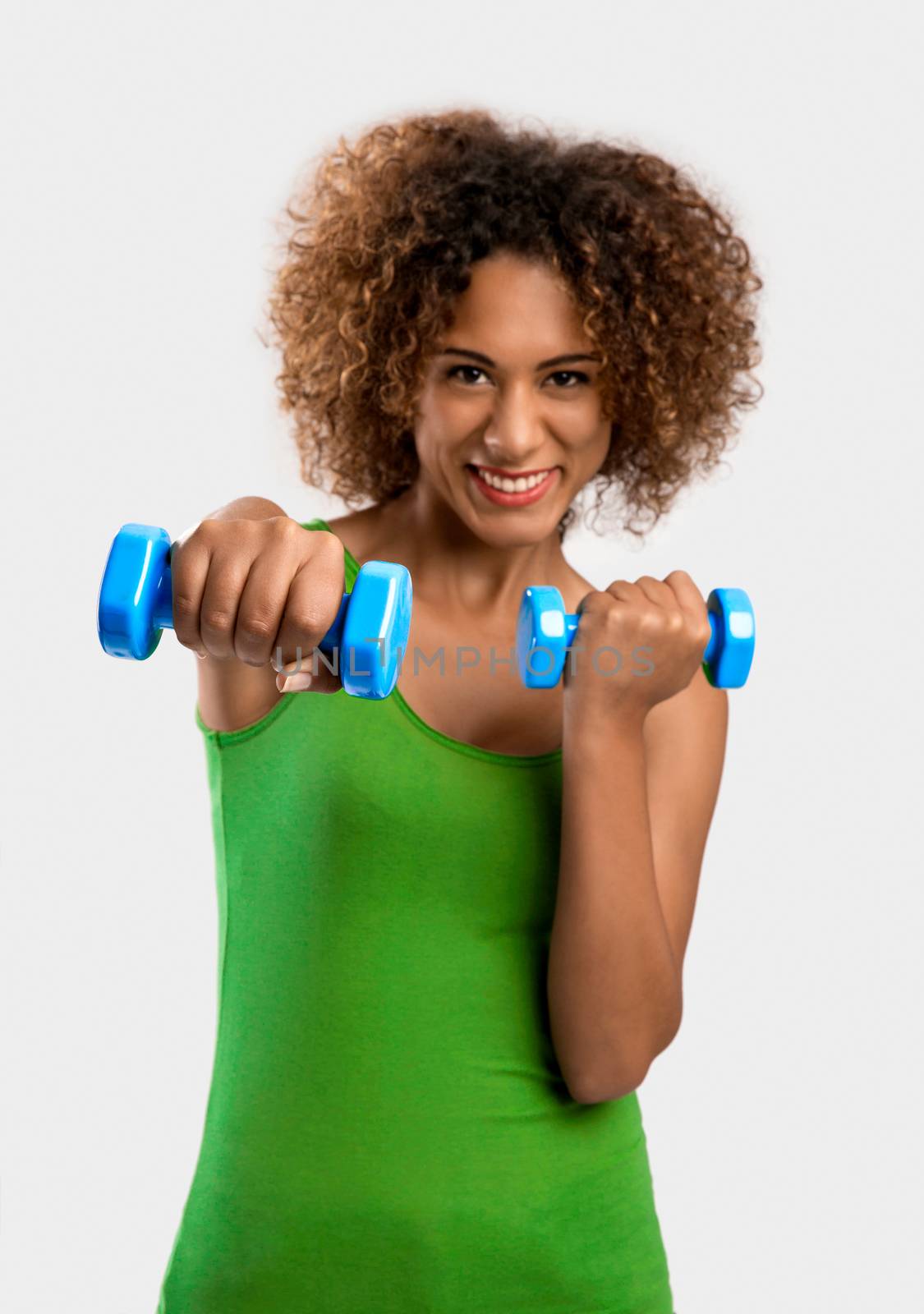 Beautiful African American woman lifting weights 