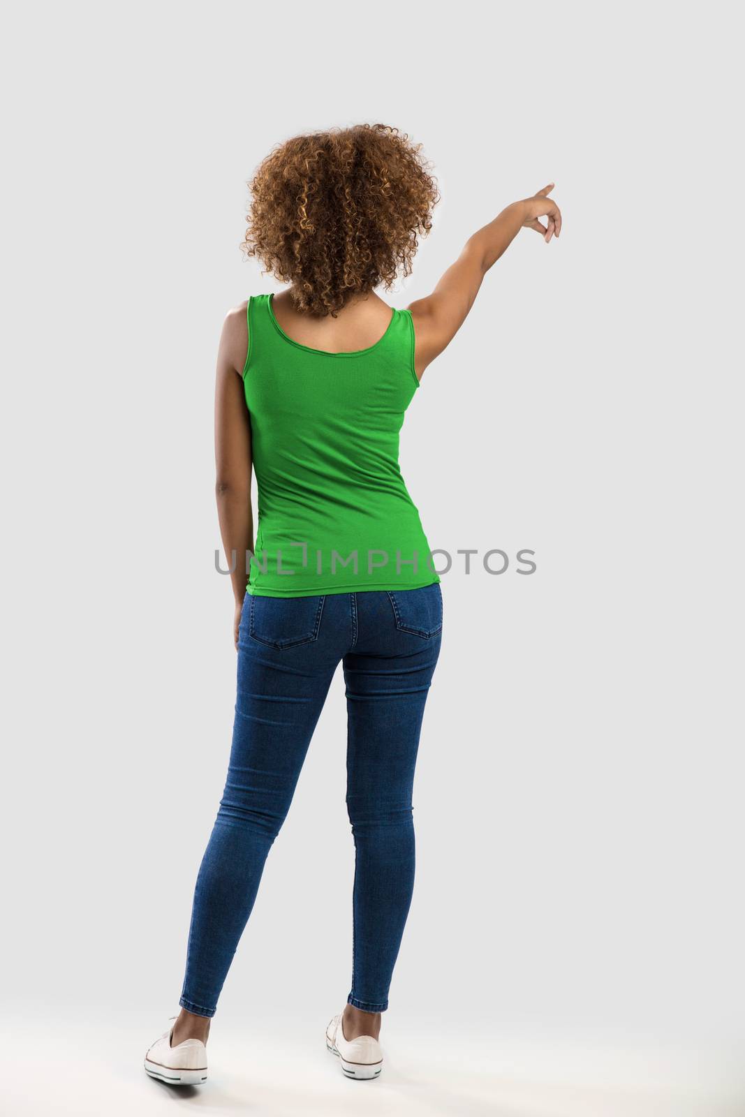 Beautiful African American woman pointing to somewhere