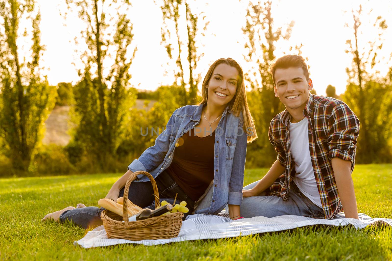 Shot of a beautiful couple on the park making a picnic and having fun