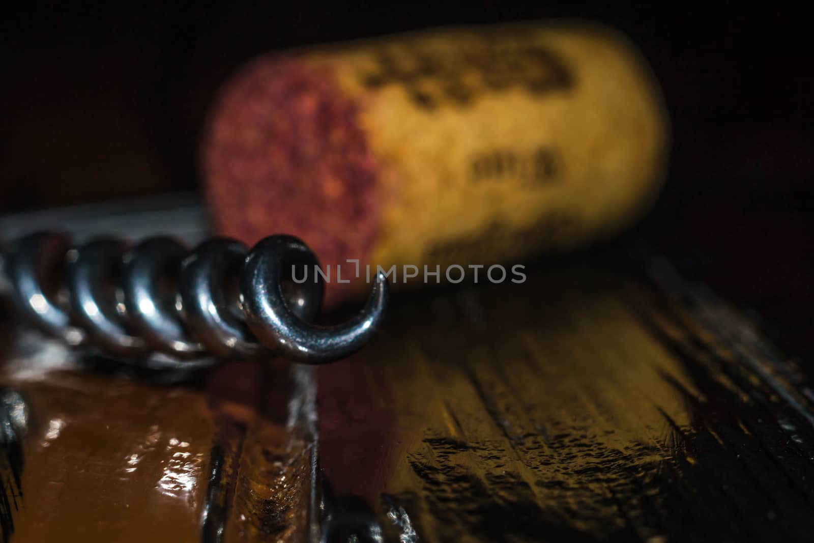 a corkscrew on a wooden table color glow bottle stopper wine