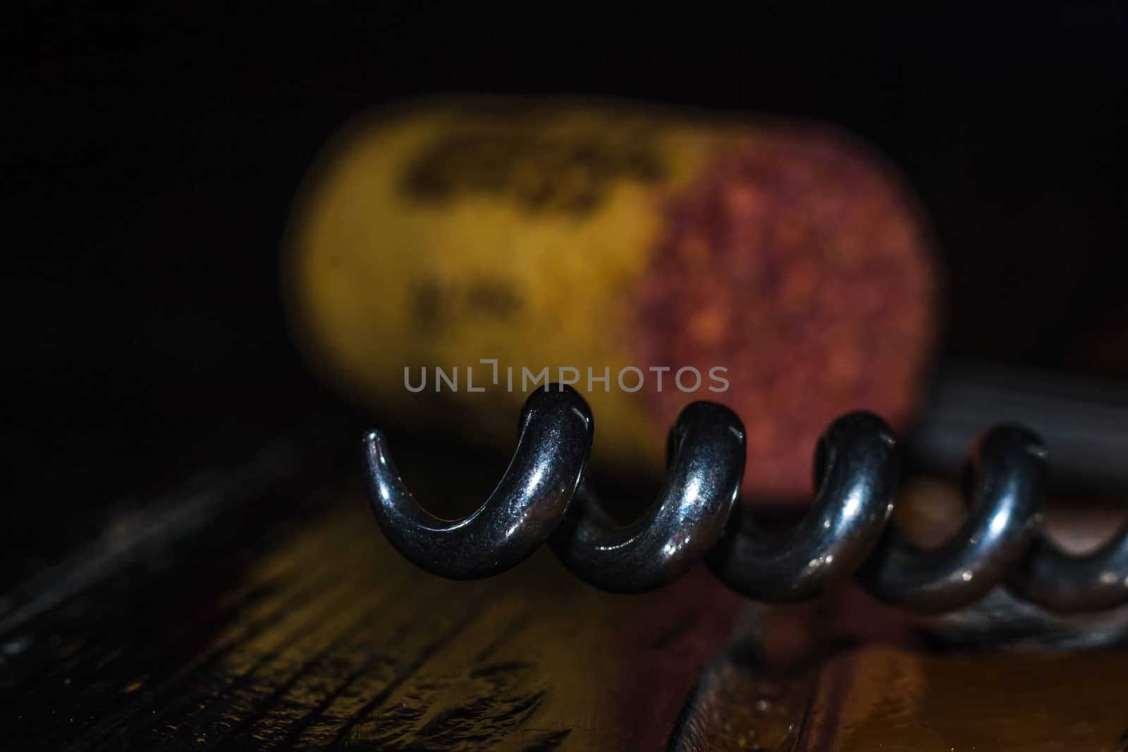 a corkscrew on a wooden table color glow bottle stopper wine