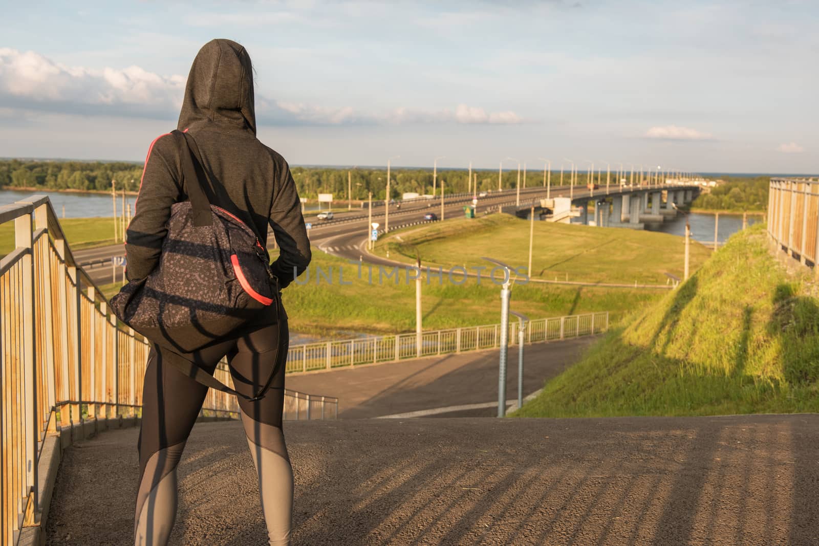 A woman in sportswear on evening city background