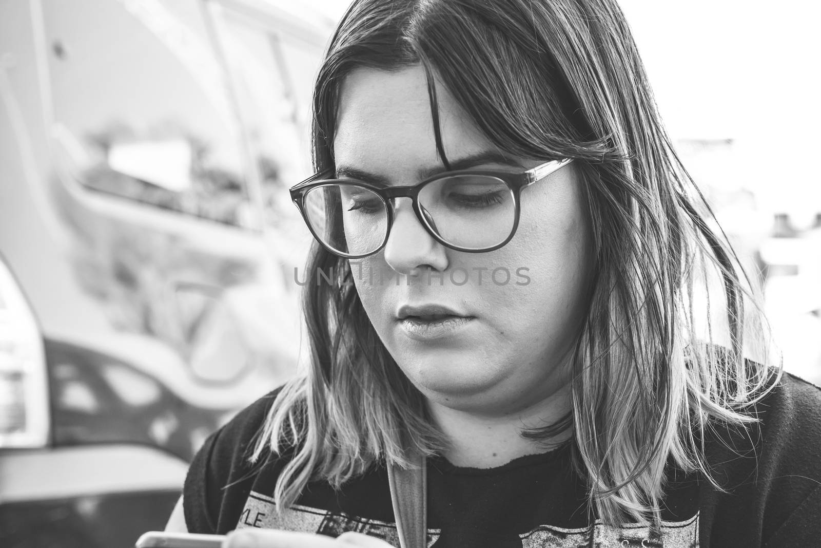 Woman using smartphone on the street. Close up black white image.