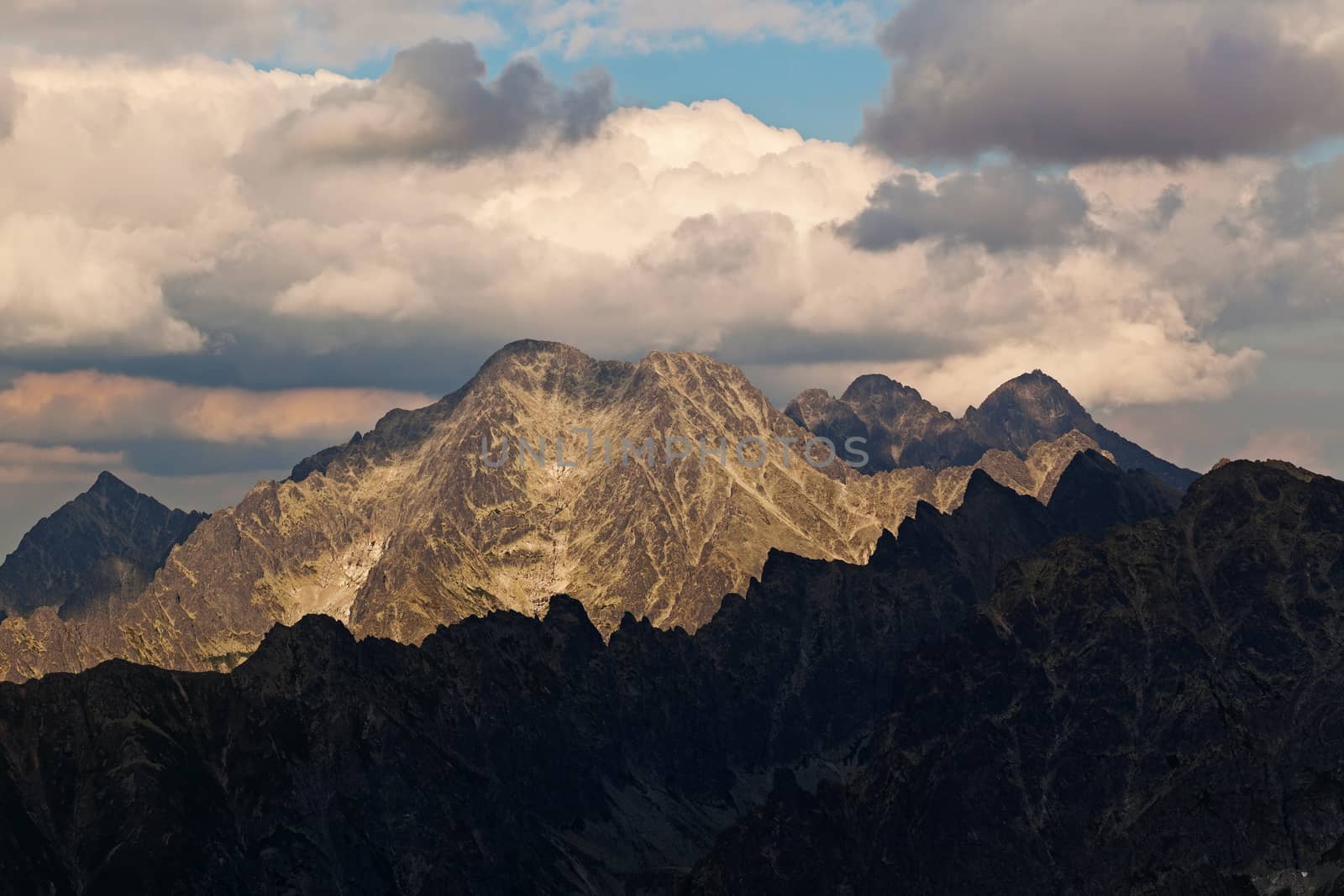 View on high rocky peak in Tatra Mountains. We can see Lomnicky Stit peak faf far awey