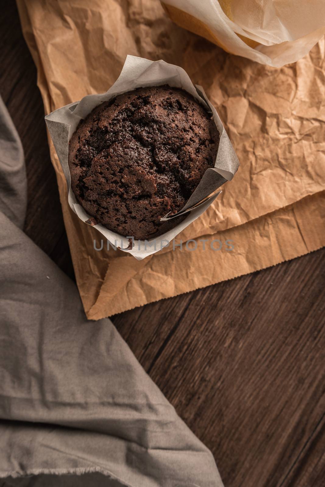 Homemade muffins with chocolate and baking ingredients.