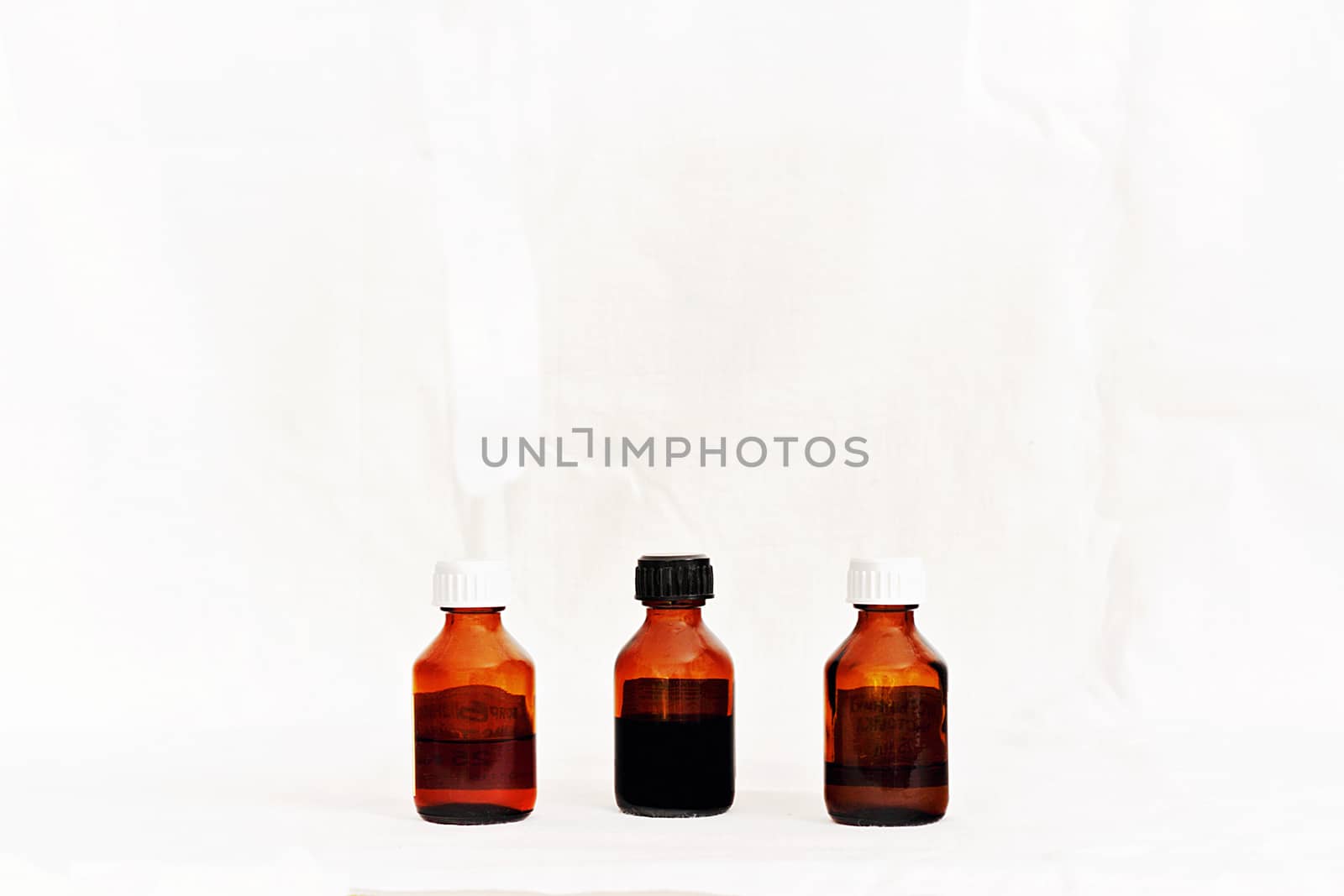 Three bottles with medicinal tinctures isolated white background.