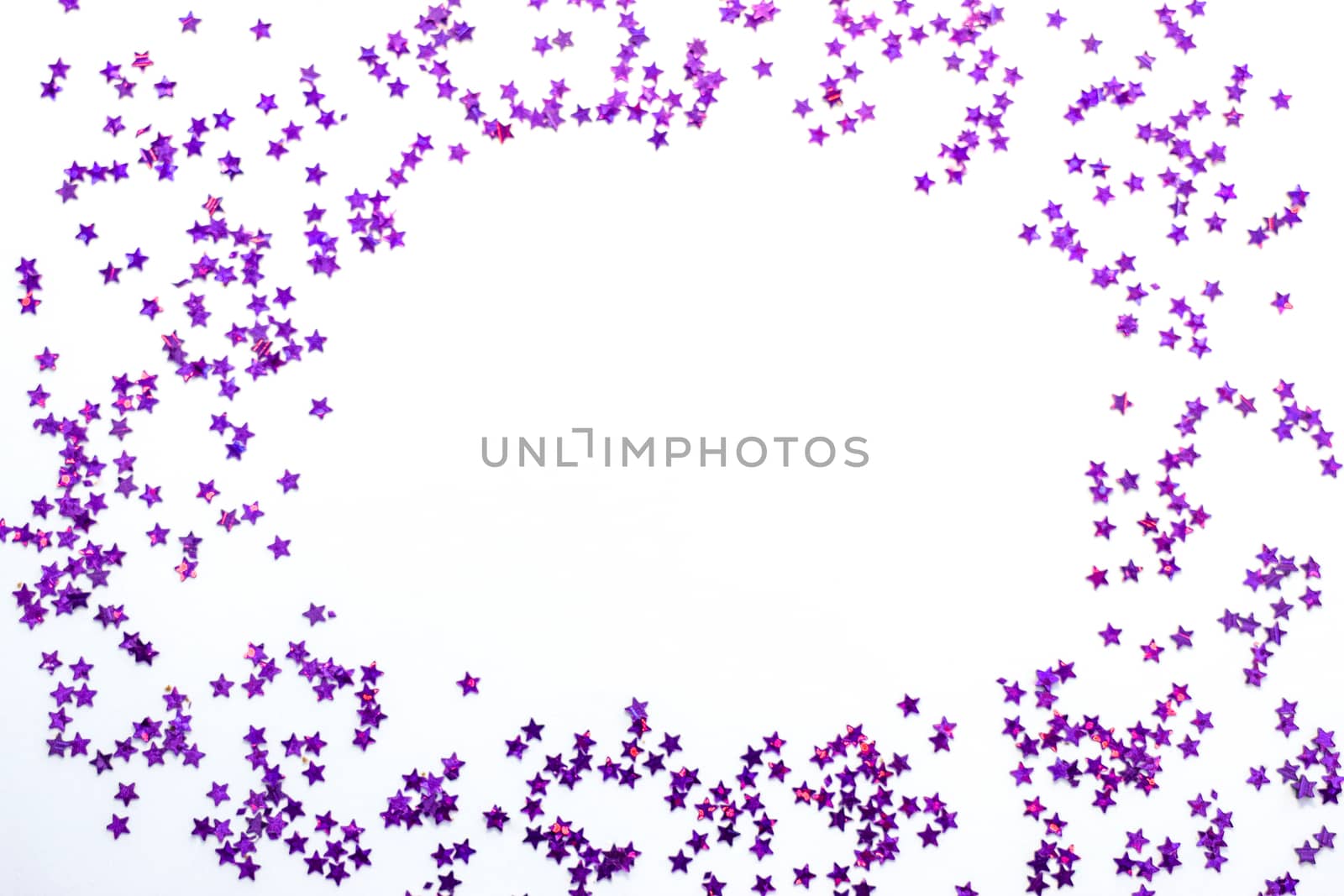 Purple glitter stars on a white background with copy space