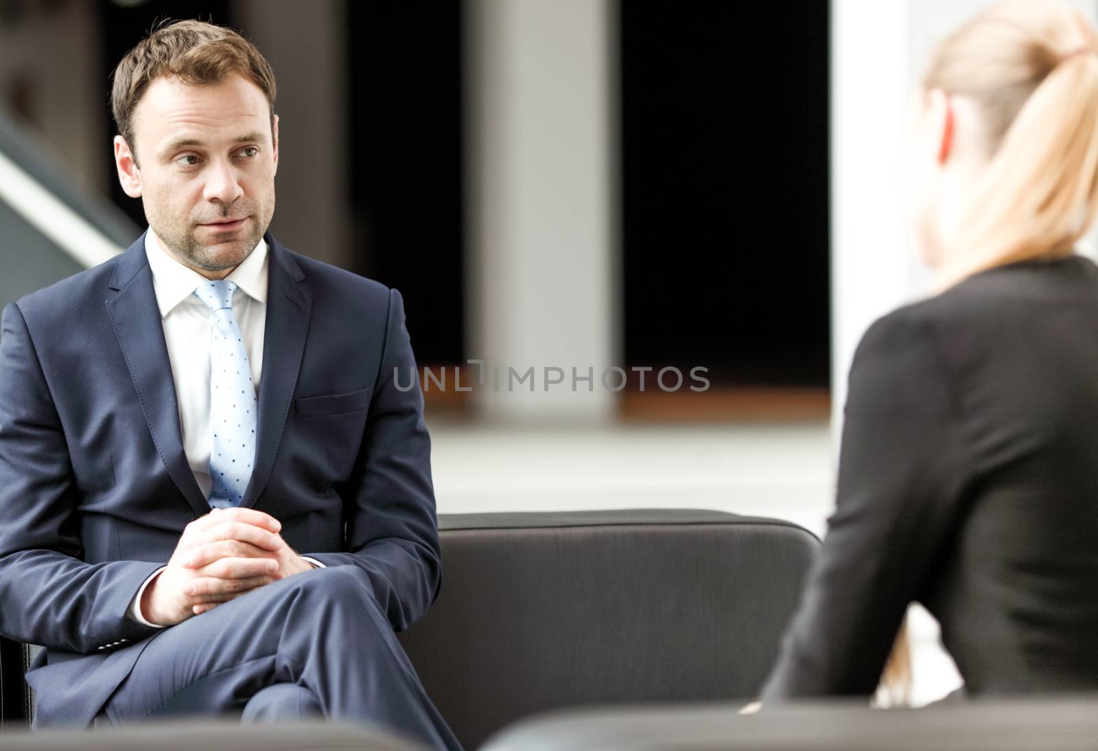 Business people talking sitting on sofa at office lobby, break, interview concept