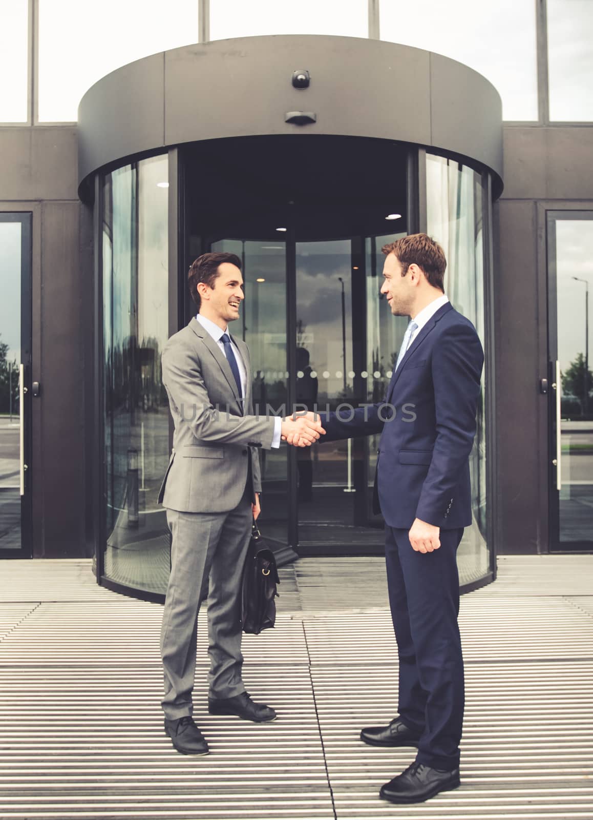 Business people shaking hands by ALotOfPeople