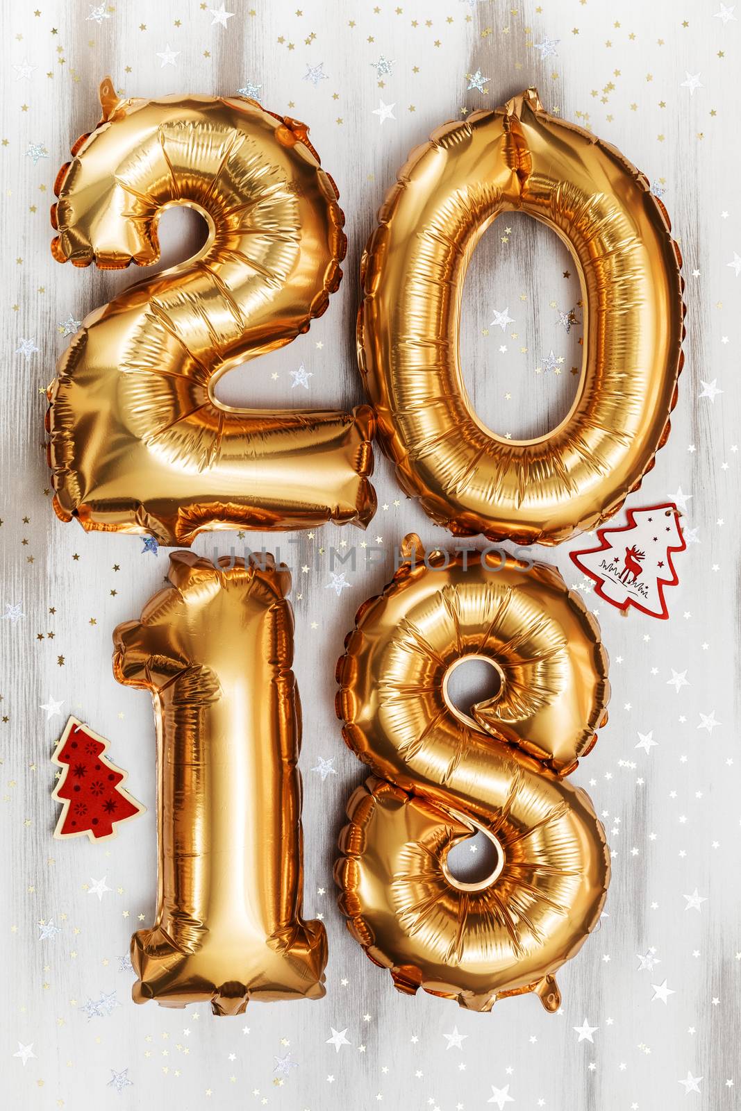 Bright gold balloons figures 2018, New Year Balloons with glitter stars on white wood table background. Christmas and new year celebration