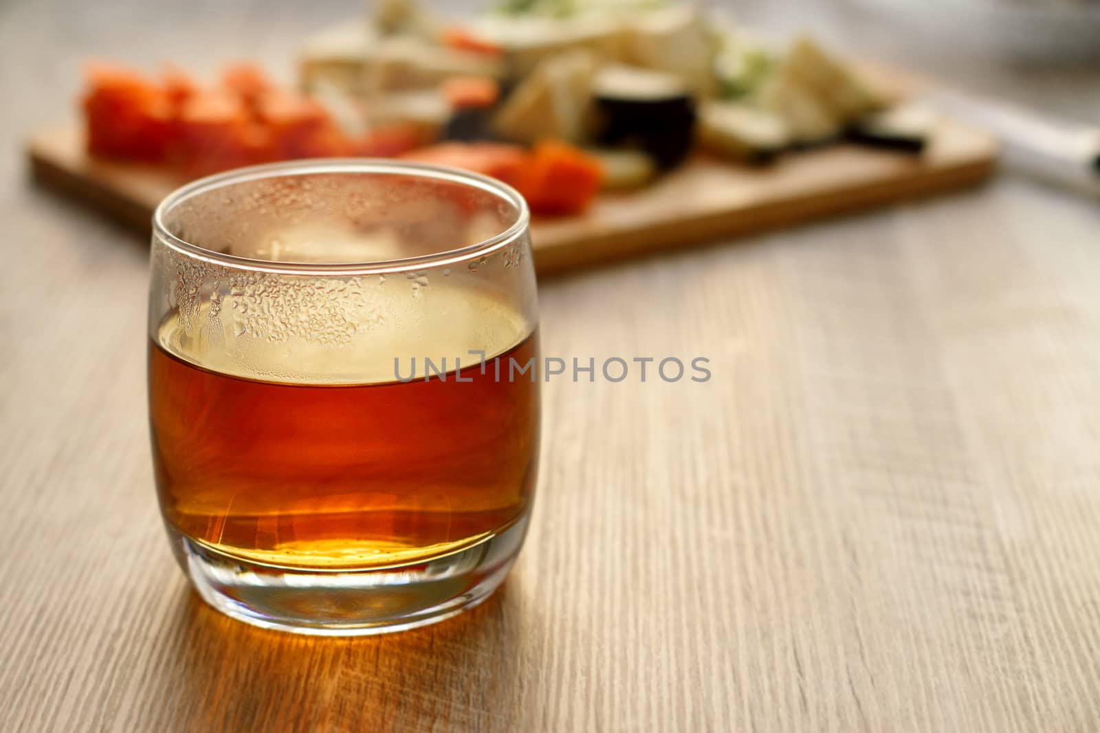 Hot tea in a glass, in backlight, against the background of products.