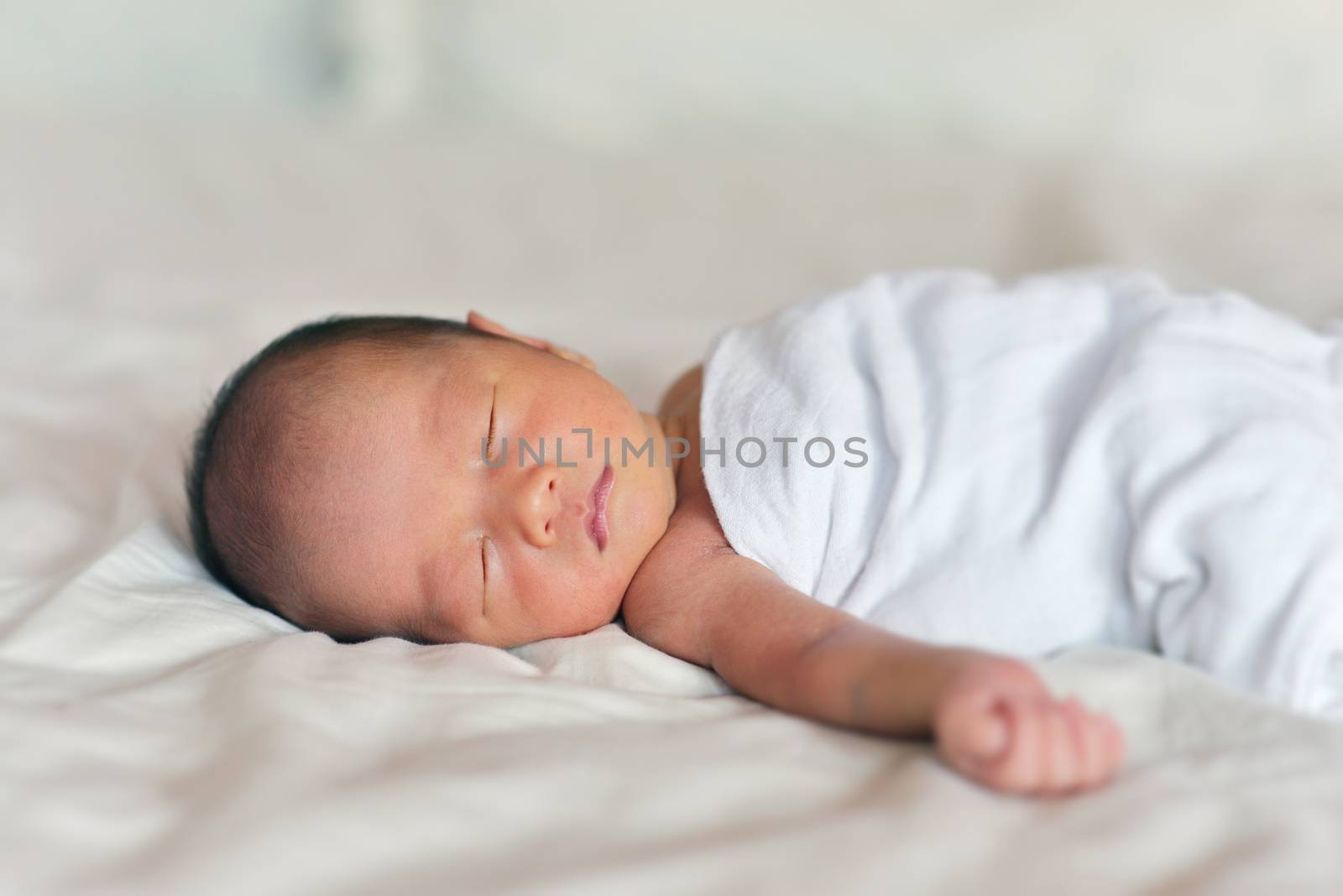 Sleeping Asian newborn baby boy, 7 days old.