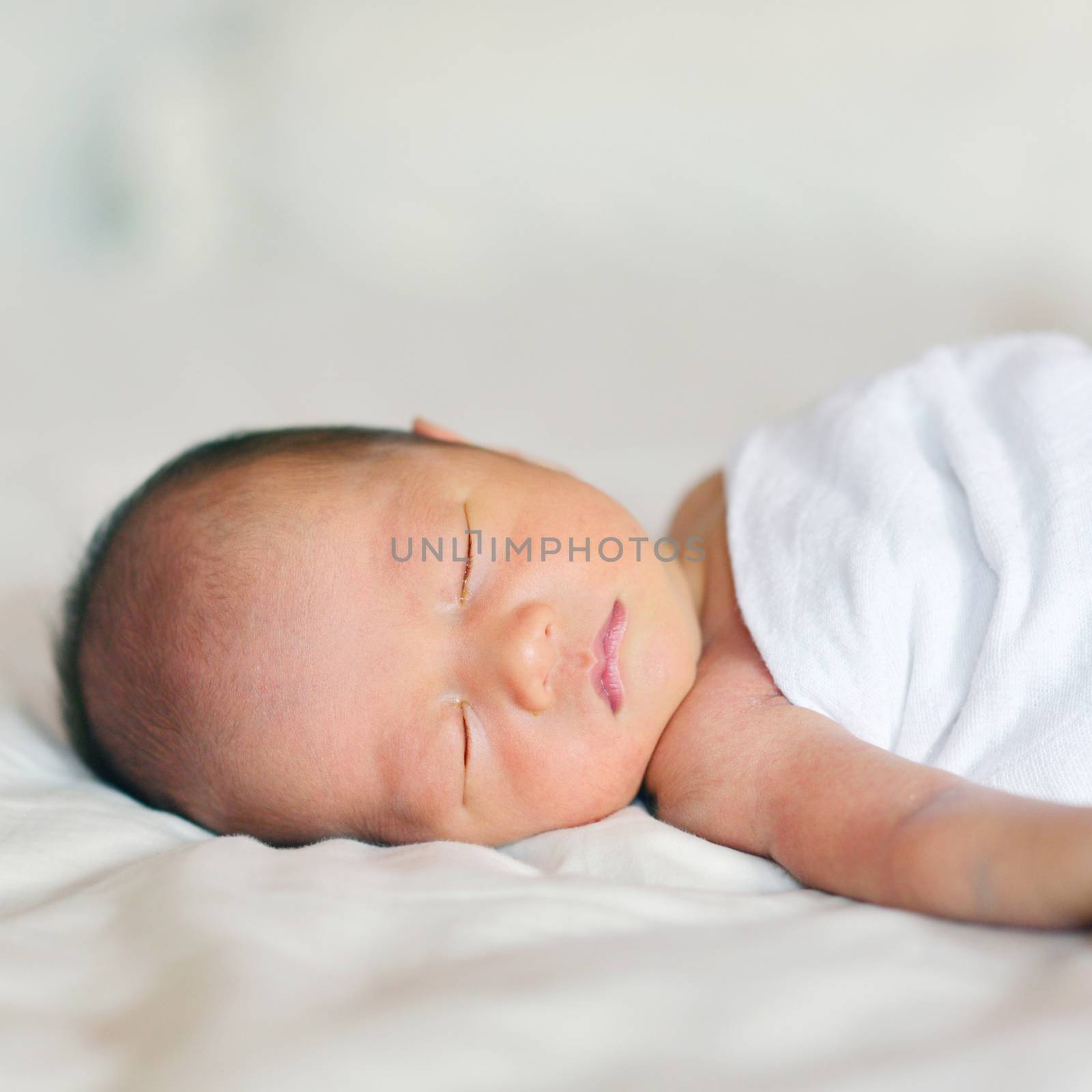 Little Asian newborn baby boy 7 days, sleeps.