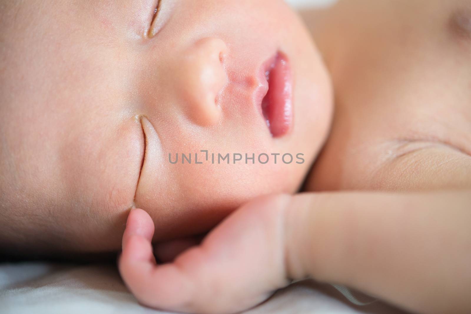 Close-up portrait of a beautiful sleeping baby boy, 7 days old.