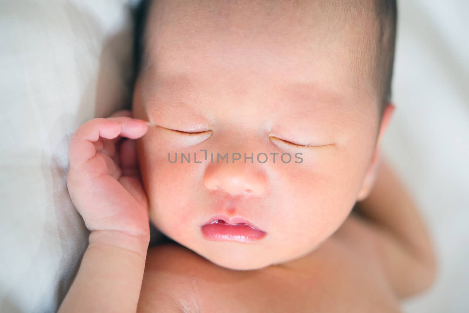 Close-up portrait of a beautiful sleeping baby boy on white.