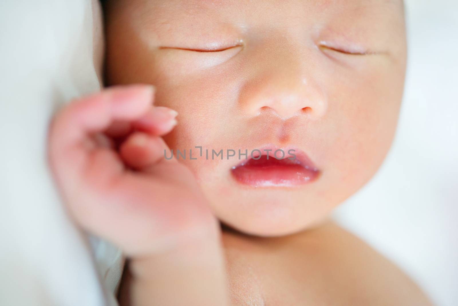 Close up little Asian newborn baby boy 1 week old, sleeps.