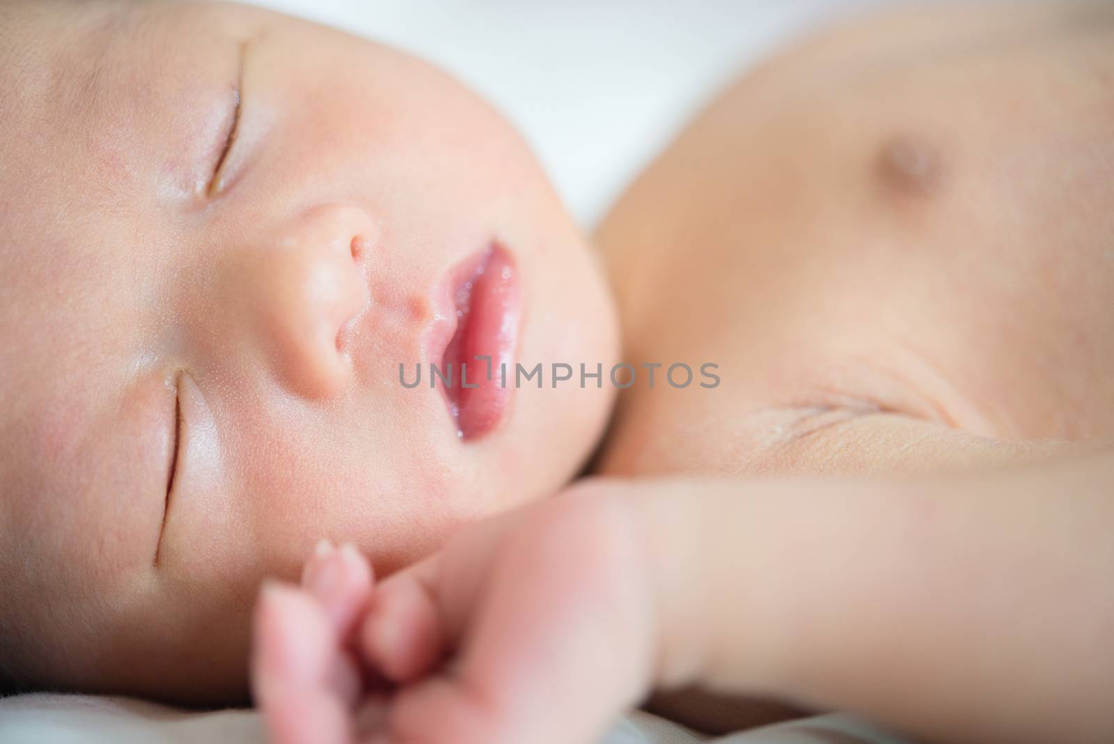 Close up Asian newborn baby boy sleeping with tenderness, 1 week old.