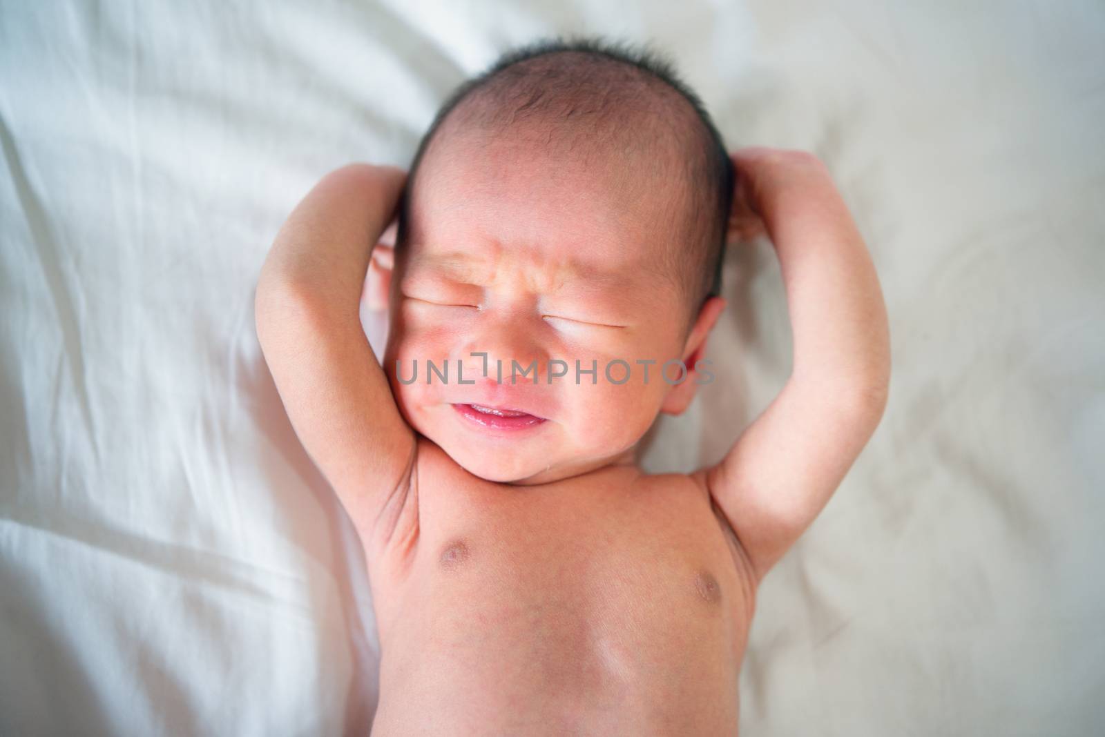 Crying little baby newborn, 7 days old.