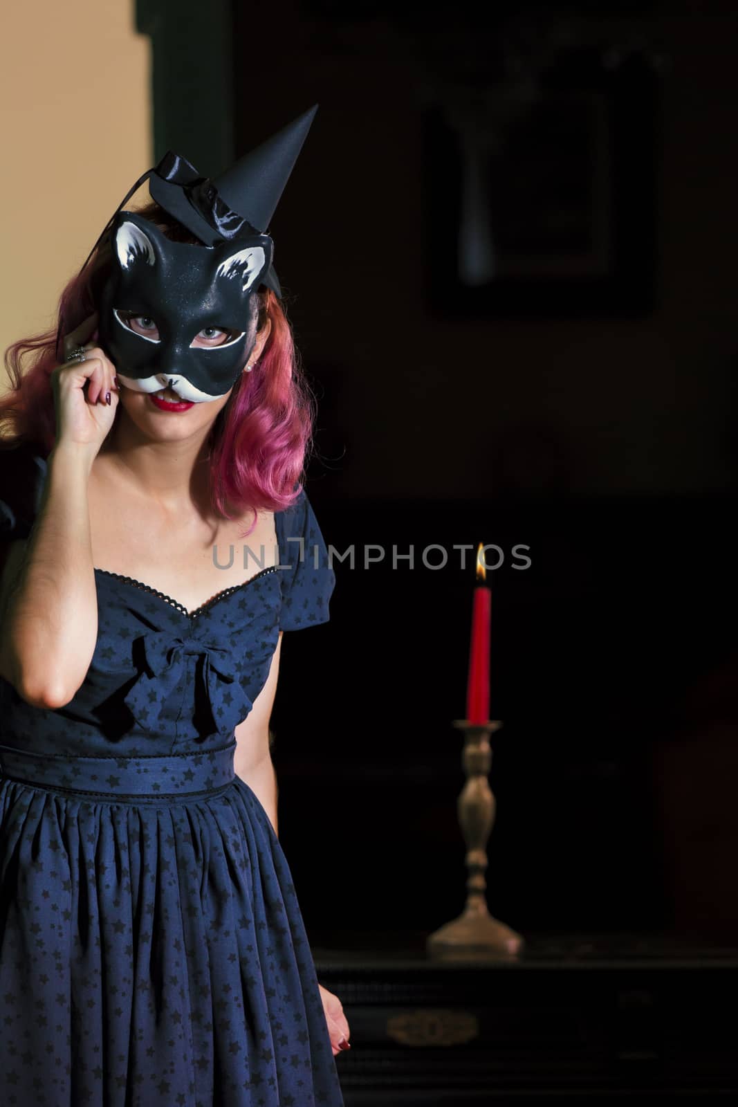 Halloween theme vintage girl wearing a cat mask.