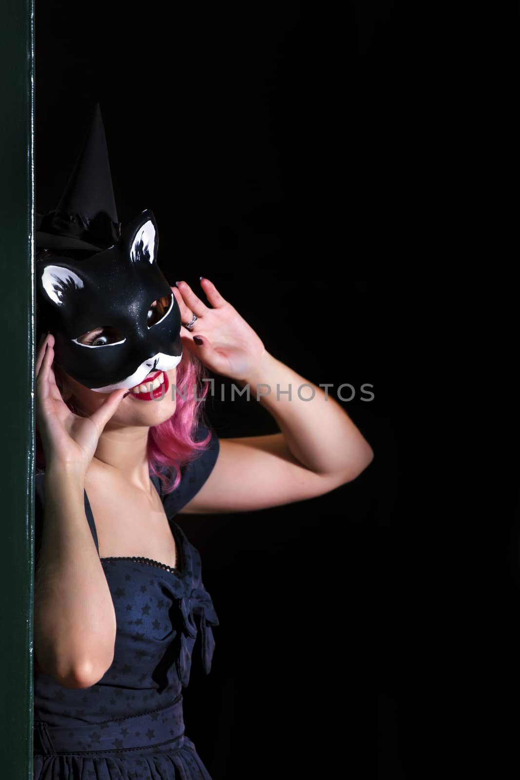 Halloween theme vintage girl wearing a cat mask.