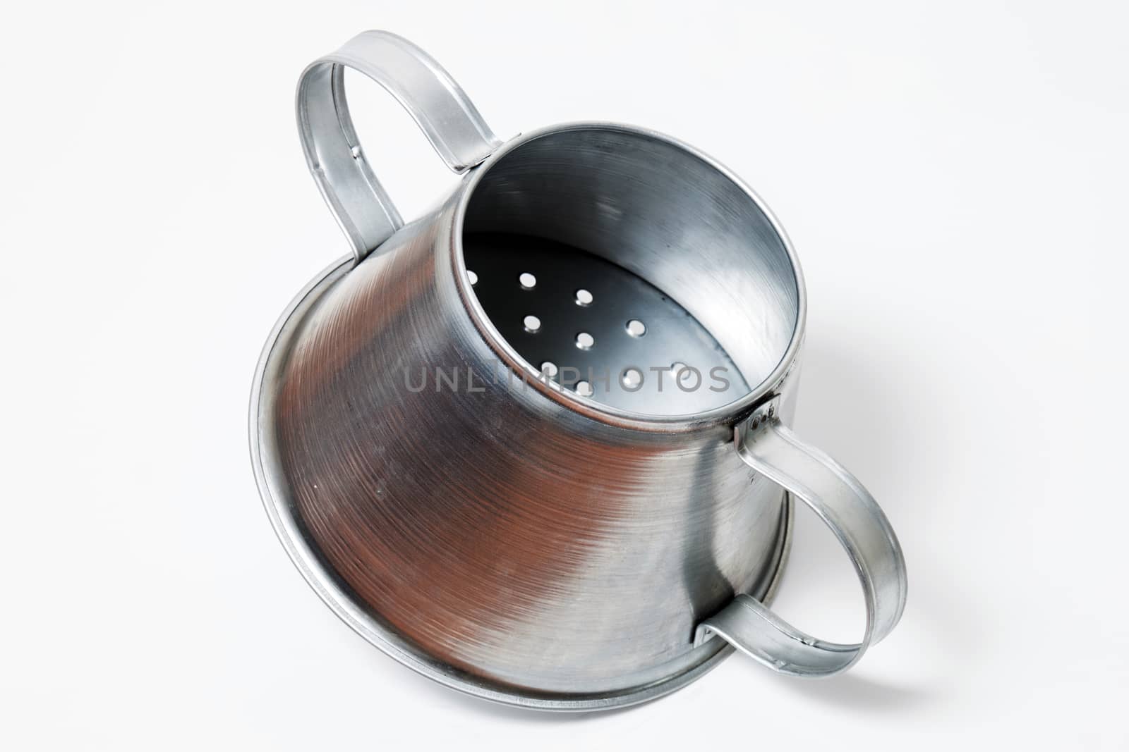 Close view of a metal rustic chestnut roaster isolated on a white background.