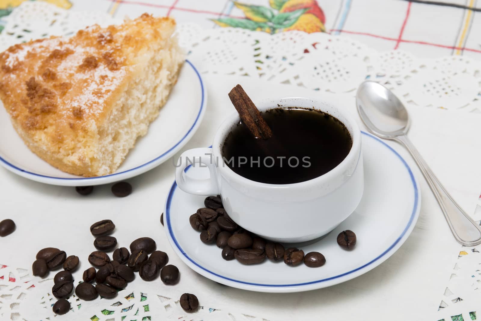 Close view of breakfast with coffee and a piece of coconut cake.