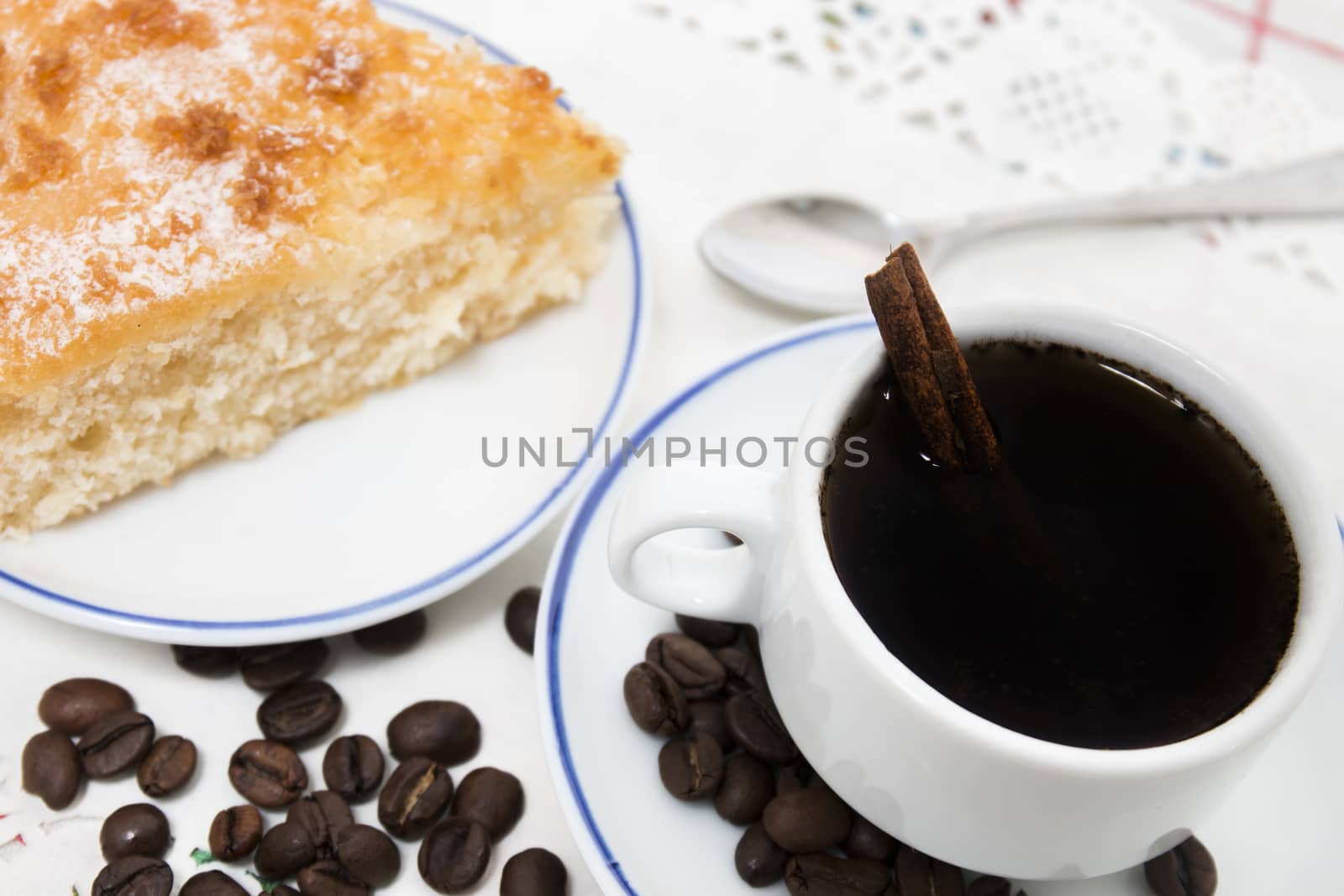 Close view of breakfast with coffee and a piece of coconut cake.