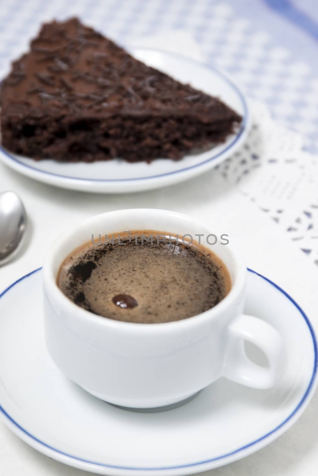 Composition of the classic coffee cup espresso with a piece of brigadeiro cake.